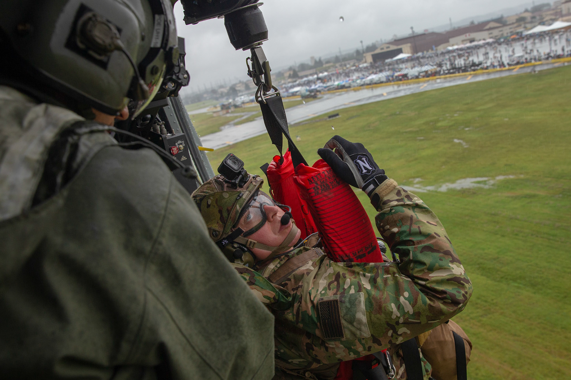 Tech. Sgt. Justin Bender, 374th Operations Support Squadron survival, evasion, resistance and escape specialist, is hoisted into a UH-1N Iroquois during a Capabilities Exercise as part of the 2018 Japanese-American Friendship Festival at Yokota Air Base, Japan, Sept. 15, 2018. Members with the 459th AS showcased their rescue capabilities to execute search-and-rescue mission. (U.S. Air Force photo by Yasuo Osakabe)