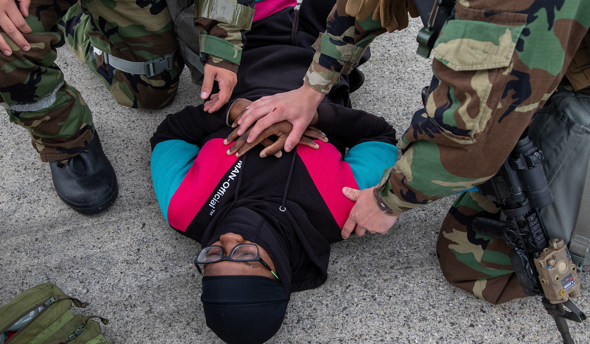 (Left to right) Airman 1st Class John Maclean and Gerardo Cameros, 374th Security Forces Squadron patrolmen, secure a simulated hostage during an anti-hijacking exercise at Yokota Air Base, Japan, May 5, 2021. Team Yokota members participated in a two-week-long Samurai Readiness Inspection exercise which ensures the base is ready to respond to potential contingencies in the area. (U.S. Air Force photo by Yasuo Osakabe)
