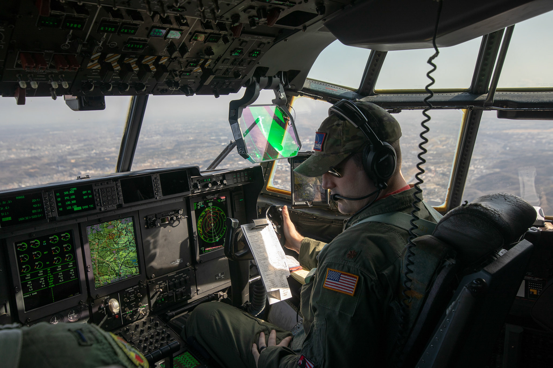 Maj. Daniel Gnazzo, 36th Airlift Squadron flight commander, communicates with his crewmembers over the Kanto Plain, March 22, 2019, during the Yokota C-130J Rodeo. The Rodeo is a tactical airlift competition between flights within the 36th Airlift Squadron and 374th Operations Support Squadron, whose goal is to demonstrate capabilities, improve procedures, and enhance standardization for global operations.  (U.S. Air Force photo by Yasuo Osakabe)