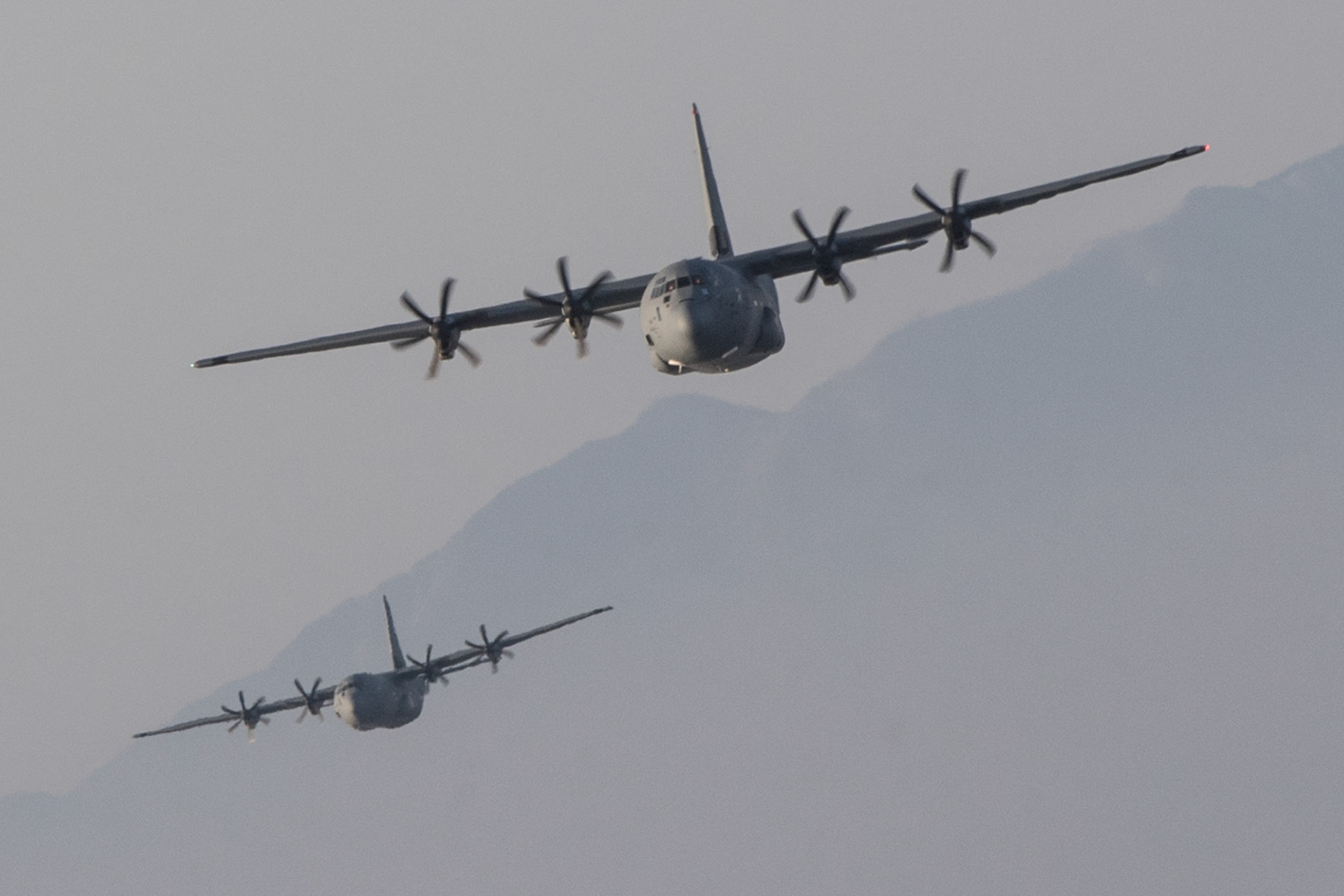Two Air Force C-130J Super Hercules assigned to the 36th Airlift Squadron fly over Sizuoka prefecture, Japan, March 26, 2018. The C-130J provides tactical airlift worldwide. Its flexible design allows it the capability to operate in austere environments. (U.S. Air Force photo by Yasuo Osakabe)