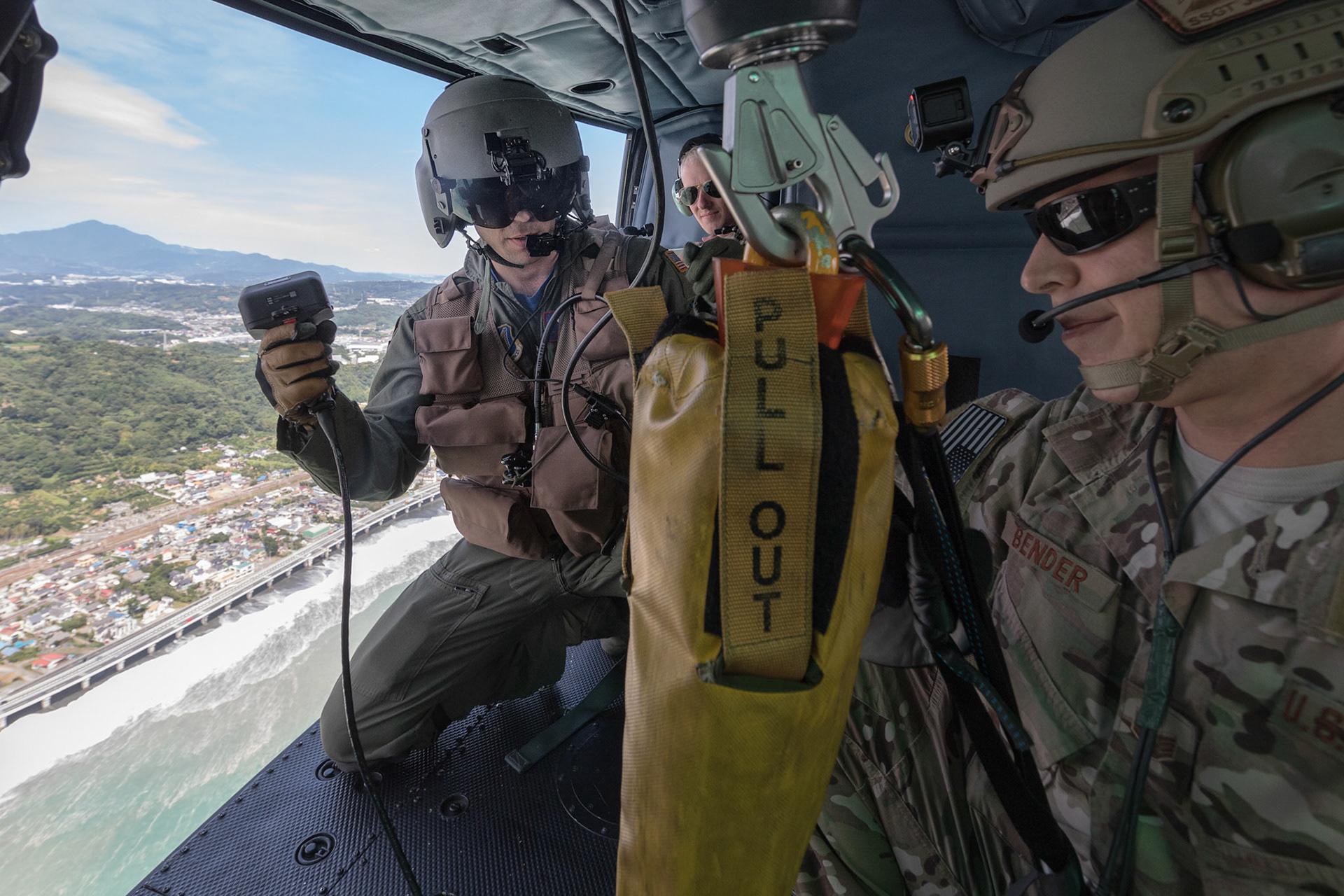 (Left to right) Tech. Sgt. Nicholas Poe, 459th Airlift Squadron special missions aviator, and Staff Sgt. Justin Bender, 374th Operations Support Squadron survival, evasion, resistance and escape specialist, check a forest penetrator over Sagami Bay, Japan, Sept. 1, 2017, during the 2017 Big Rescue Kanagawa Disaster Prevention Drill. Airmen of the 459 AS demonstrated their rescue capabilities among local participants during the Big Rescue Kanagawa for the first time. (U.S. Air Force photo by Yasuo Osakabe)