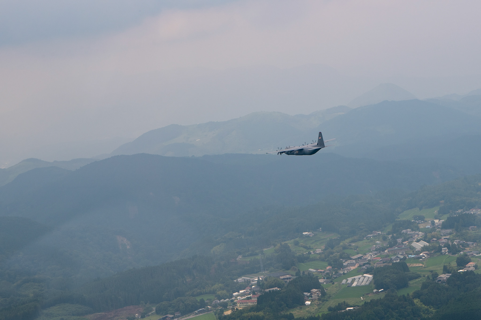 A U.S. Air Force C-130J Super Hercules assigned to the 36th Airlift Squadron conducts flight training over Mount Aso, Japan, July 16, 2019, during a bilateral jump training. The training allows USAF and JGSDF units to work alongside each other while improving the readiness of our armed forces. (U.S. Air Force photo by Yasuo Osakabe)
