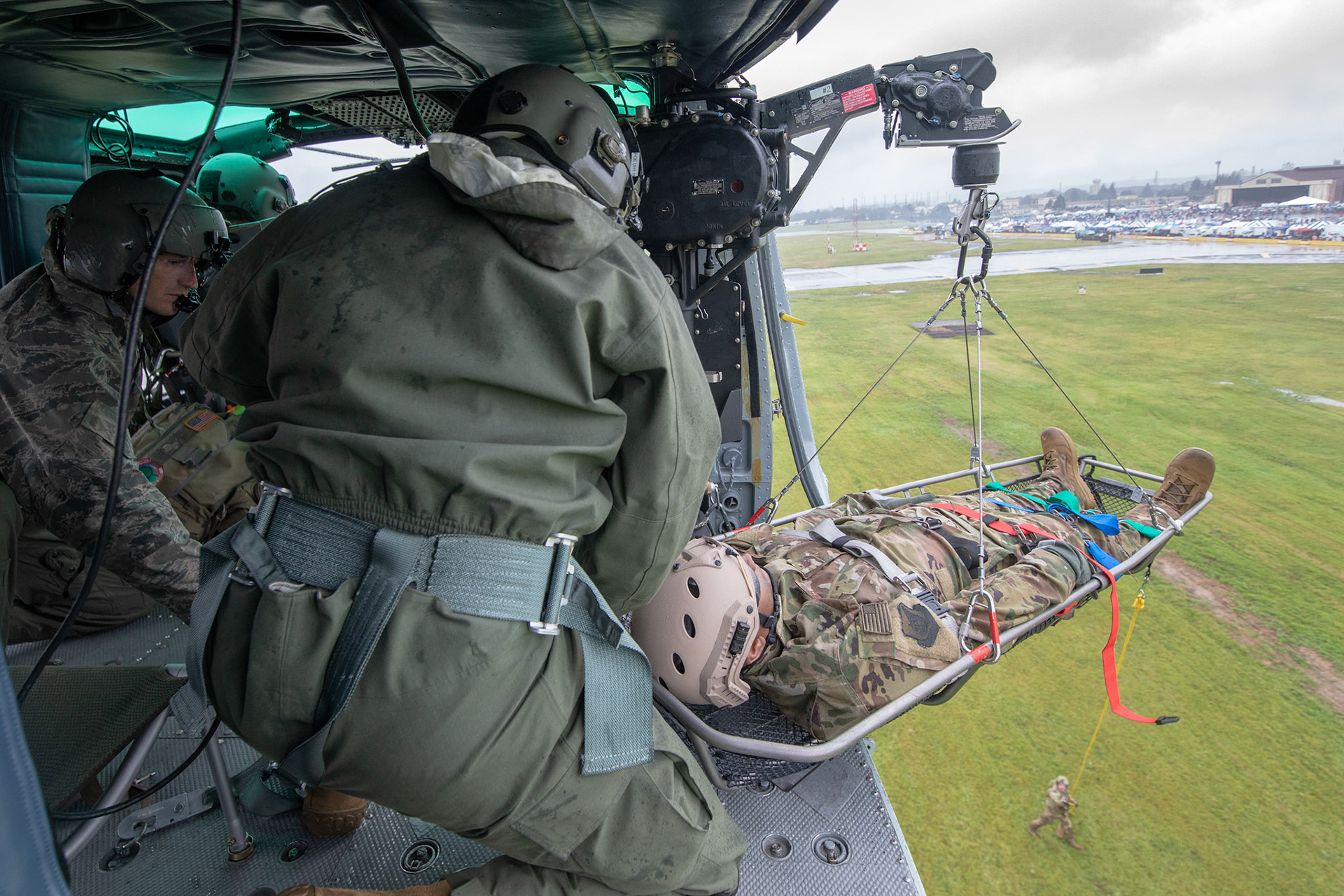 Tech. Sgt. Nicholas Poe and Dustin Sheffield, both with the 459th Airlift Squadron special mission aviators, hoist a stokes stretcher onto a UH-1N Iroquois helicopter  during a Capabilities Exercise as part of the 2018 Japanese-American Friendship Festival at Yokota Air Base, Japan, Sept. 15, 2018. Members with the 459th AS showcased their rescue capabilities to execute search-and-rescue mission. (U.S. Air Force photo by Yasuo Osakabe)