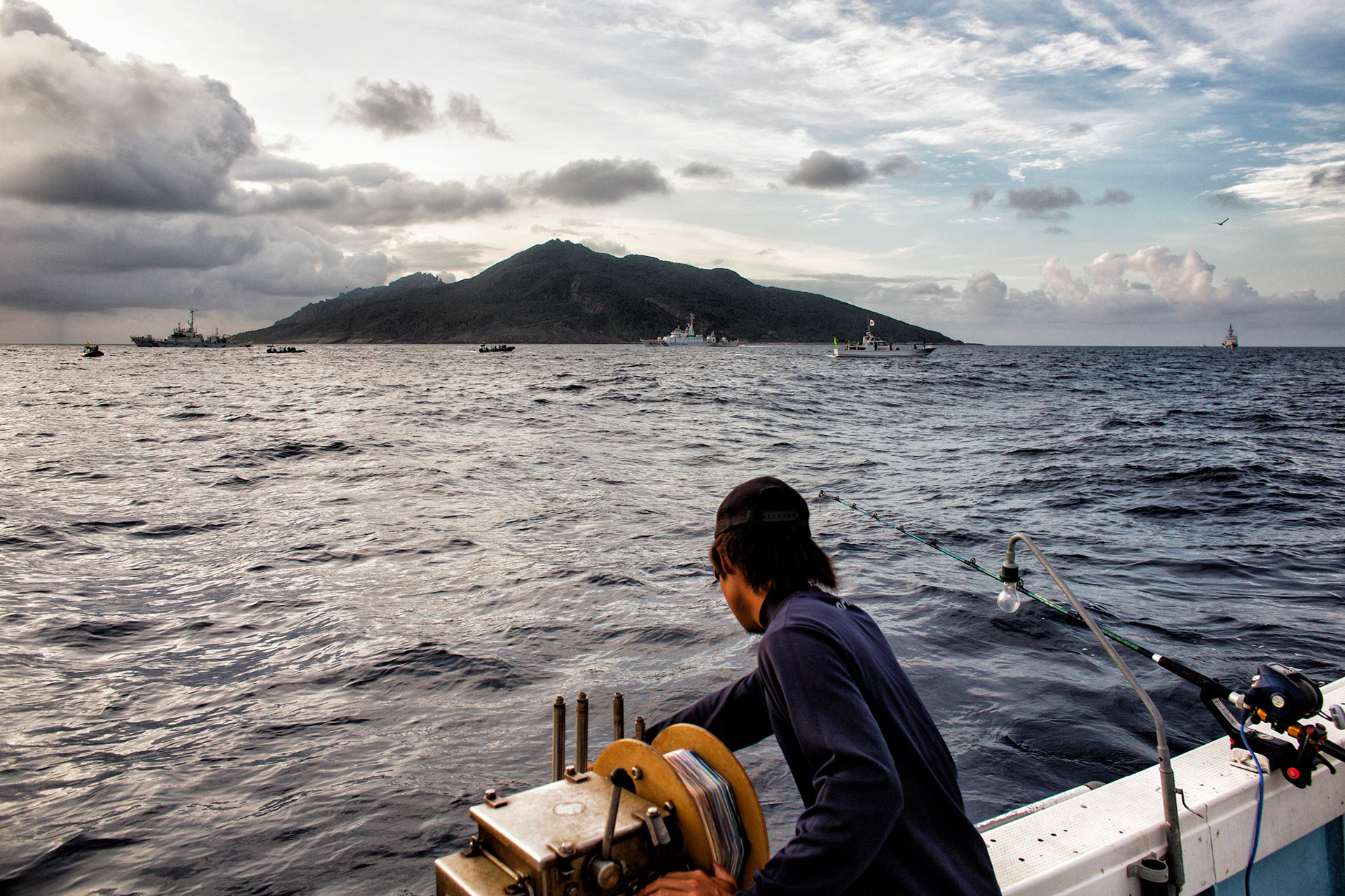 SENKAKU ISLANDS, Japan – A commercial fisherman readies to cast his special line into the ocean at Uotsuri-jima, May 26, 2013. Japanese Coast Guard vessels near Uotsuri-jima was protecting the island and fishermen in case of Chinaese government ships intruding into the territorial waters.  (Photo by Osakabe Yasuo)