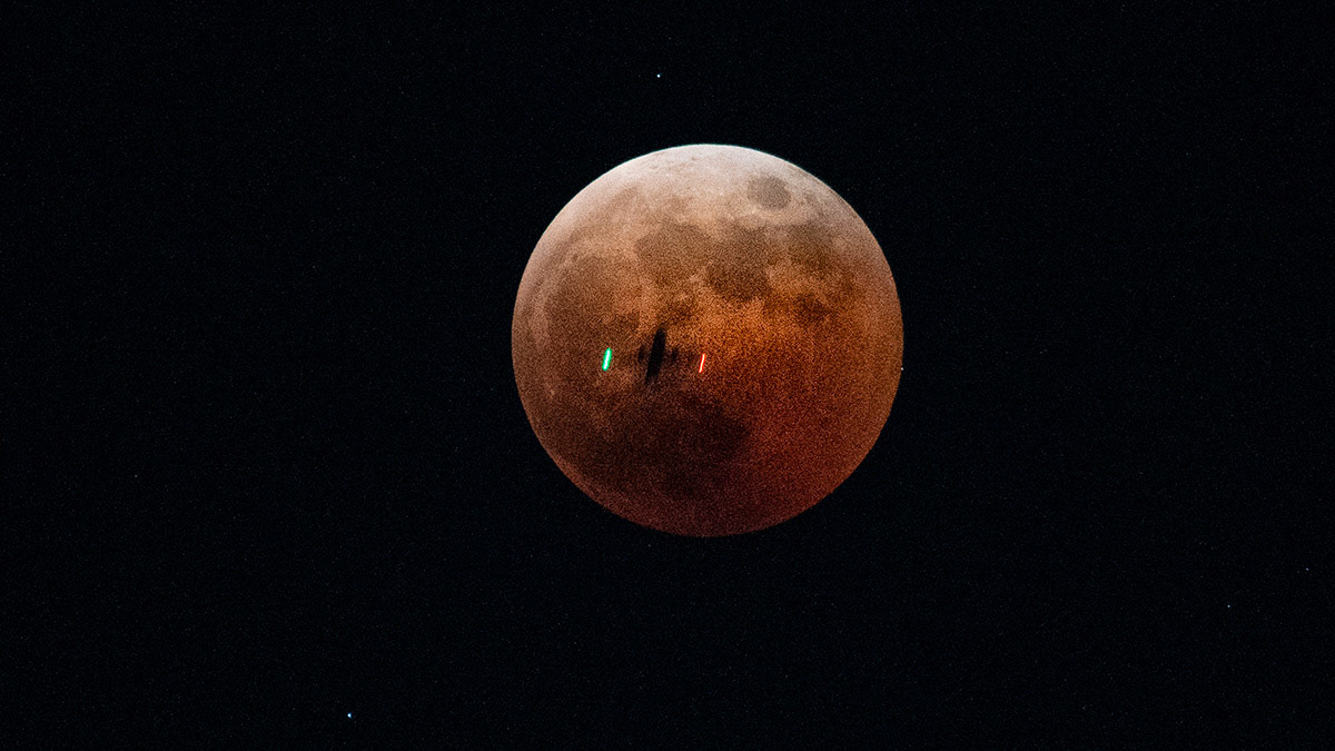 The moon sits in total lunar eclipse over the Yokota Air Base, Japan, Nov. 8, 2022. A lunar eclipse occurs when the Sun, Earth, and Moon align so that the Moon passes into Earth’s shadow. In a total lunar eclipse, the entire Moon falls within the darkest part of Earth’s shadow, called the umbra. When the Moon is within the umbra, it will turn a reddish hue. Lunar eclipses are sometimes called “Blood Moons” because of this phenomenon. (U.S. Air Force photo by Yasuo Osakabe)