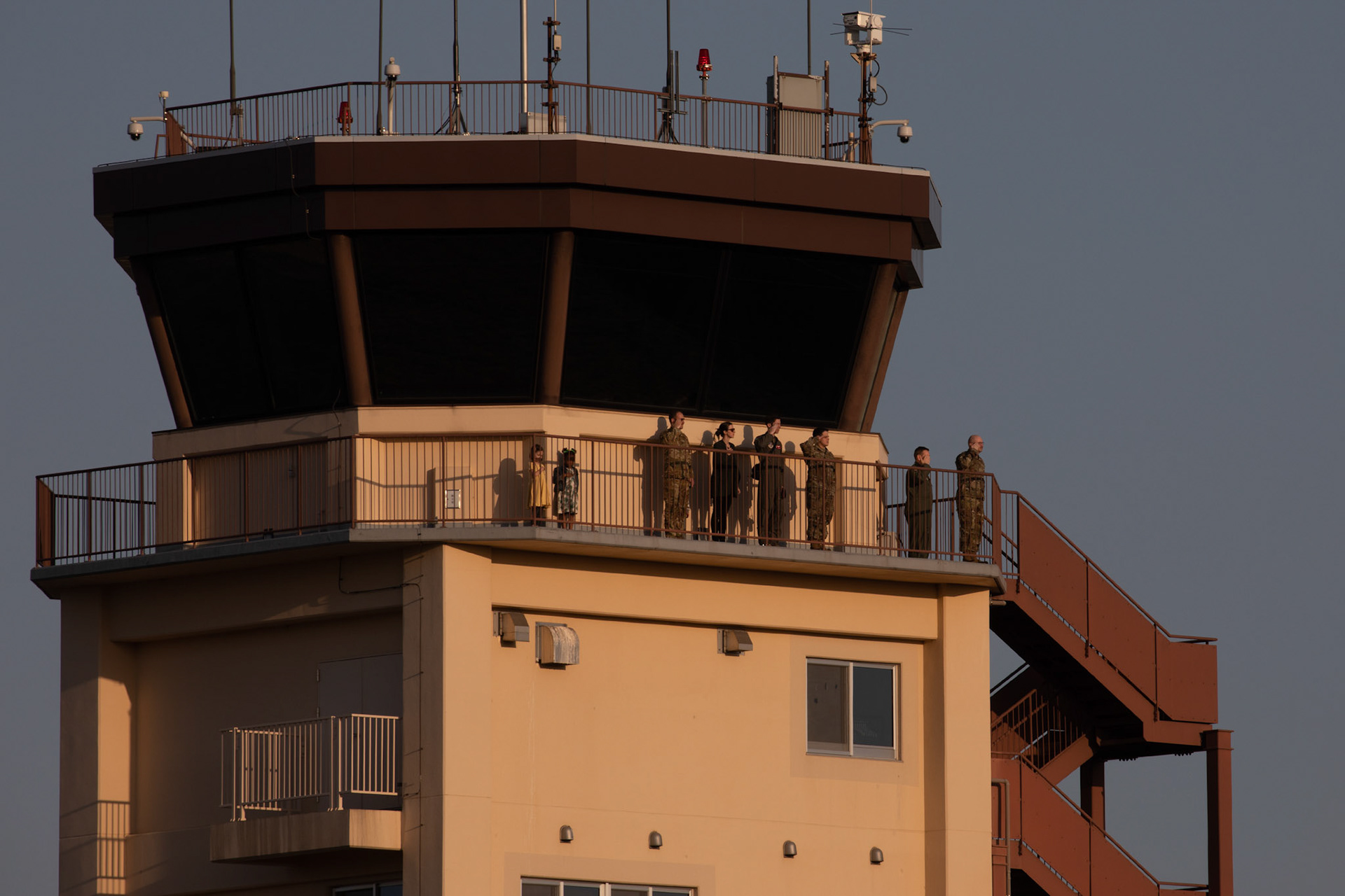 Observers with the 374th Operations Group salute during the national anthems at Yokota Air Base, Japan, March 26, 2020. (U.S. Air Force photo by Yasuo Osakabe)