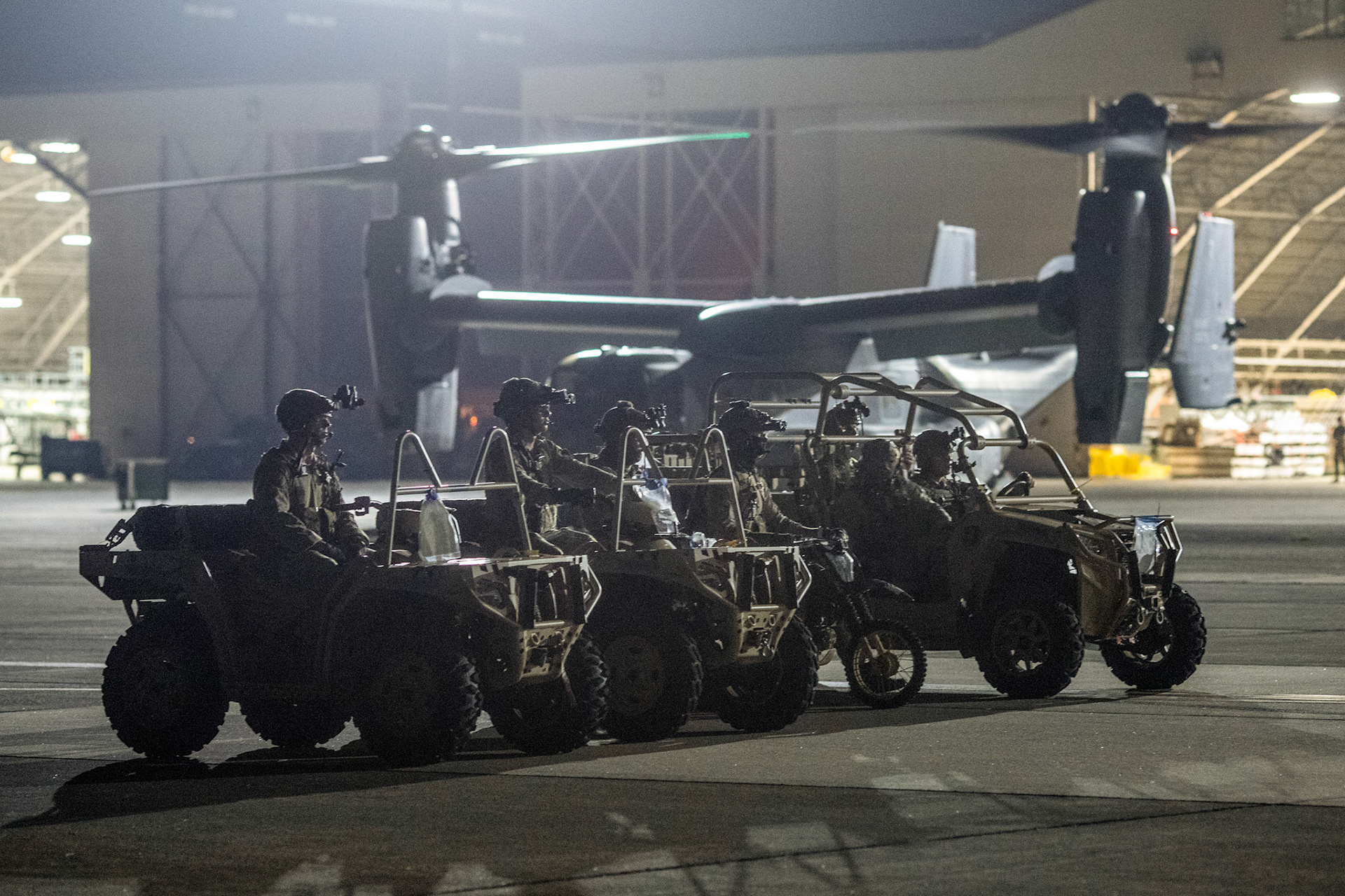 Air Force Special Tactics operators with the 320th Special Tactics Squadron out of Kadena Air Base, Japan, wait to load their tactical vehicles into a C-130J Super Hercules during an engine running onload/offload (ERO) training as part of Exercise Gryphon Jet at Yokota Air Base, Japan, June 23, 2020. Special Tactics is a U.S. Special Operation Command's tactical air and ground integration force, and the Air Force's special operations ground force, leading Global Access, Precision Strike, Personnel Recovery and Battlefield Surgery operations on the battlefield. Exercise Gryphon Jet is an integrated training exercise focused on improving interoperability throughout the special operations community. (U.S. Air Force photo by Yasuo Osakabe)