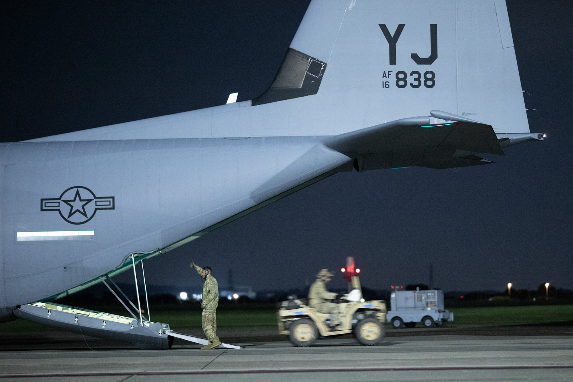 A U.S. Air Force C-130J Super Hercules' loadmaster with the 36th Airlift Squadron gives a hand to signal to Air Force Special Tactics operators with the 320th Special Tactics Squadron out of Kadena Air Base, Japan, to offload their tactical vehicles from a C-130J during an engine running onload/offload (ERO) training a part of Exercise Gryphon Jet at Yokota Air Base, Japan, June 23, 2020. Special Tactics is a U.S. Special Operation Command's tactical air and ground integration force, and the Air Force's special operations ground force, leading Global Access, Precision Strike, Personnel Recovery and Battlefield Surgery operations on the battlefield. The Exercise Gryphon Jet is an integrated training exercise focused on improving interoperability throughout the special operations community. (U.S. Air Force photo by Yasuo Osakabe)