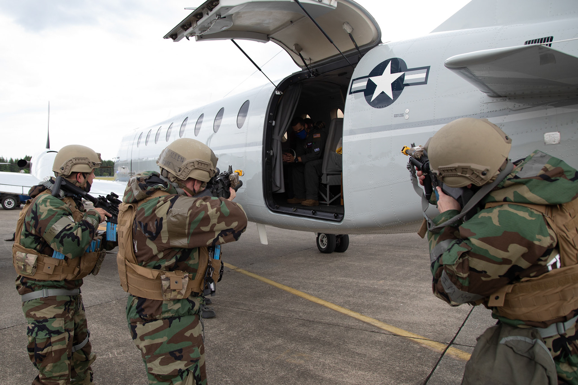 Patrolmen with the 374th Security Forces Squadron surround a simulated hijacked aircraft during an anti-hijacking exercise on the flightline at Yokota Air Base, Japan, May 5, 2021. Team Yokota members participated in a two-week-long Samurai Readiness Inspection exercise which ensures the base is ready to respond to potential contingencies in the area. (U.S. Air Force photo by Yasuo Osakabe)