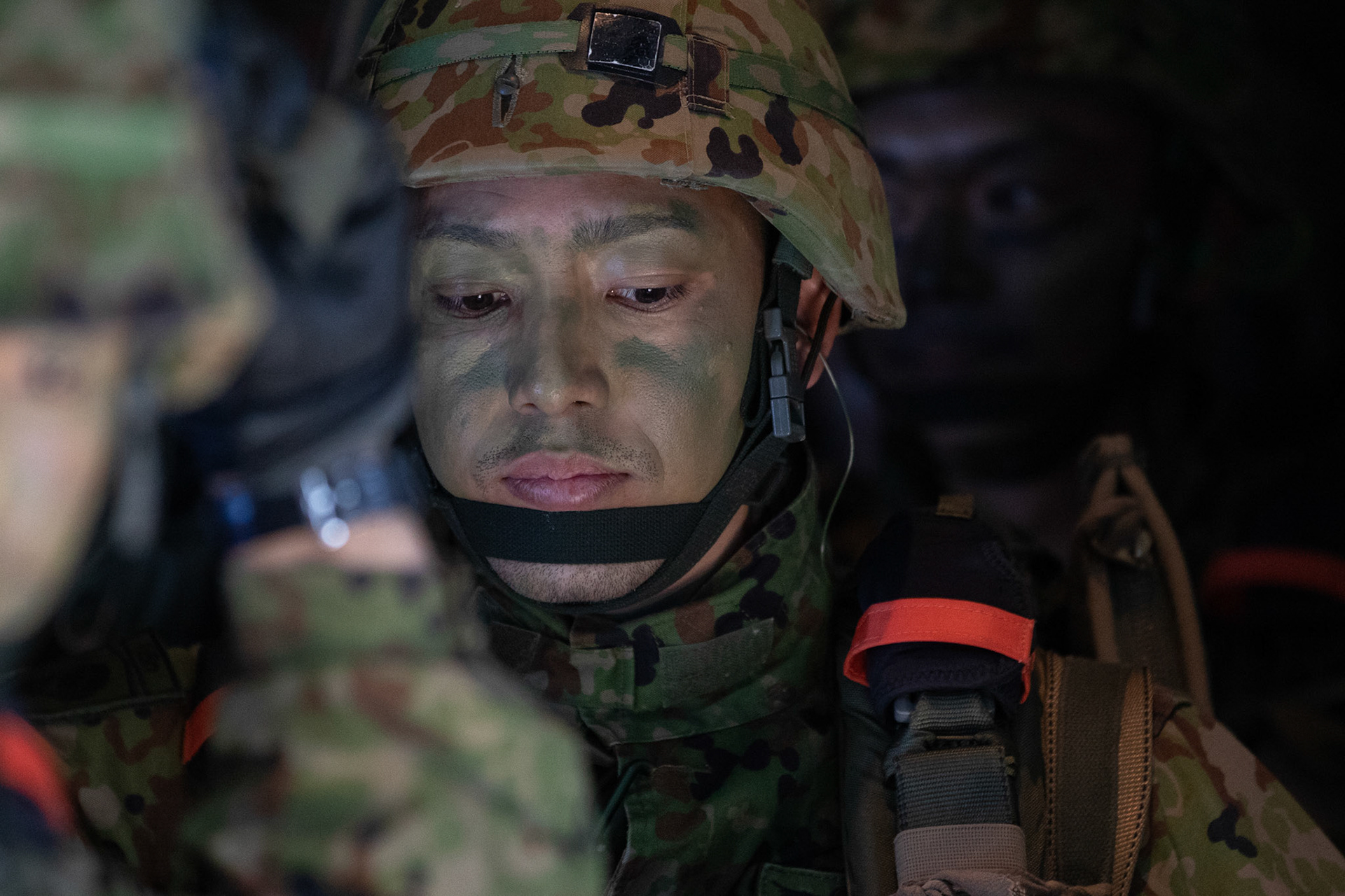 A Japan Ground Self-Defense Force soldier assigned to the 1st Airborne Brigade looks outside before conducting a jump from a U.S. Air Force C-130J Super Hercules assigned to the 36th Airlift Squadron over Hiju-dai drop zone, Oita prefecture, Japan, Nov. 4, 2018, during Keen Sword 19. Approximately 280 JGSDF personnel conducted jump training from U.S. Air Force C-130J Super Hercules’ for the first time in Japan. (U.S. Air Force photo by Yasuo Osakabe)