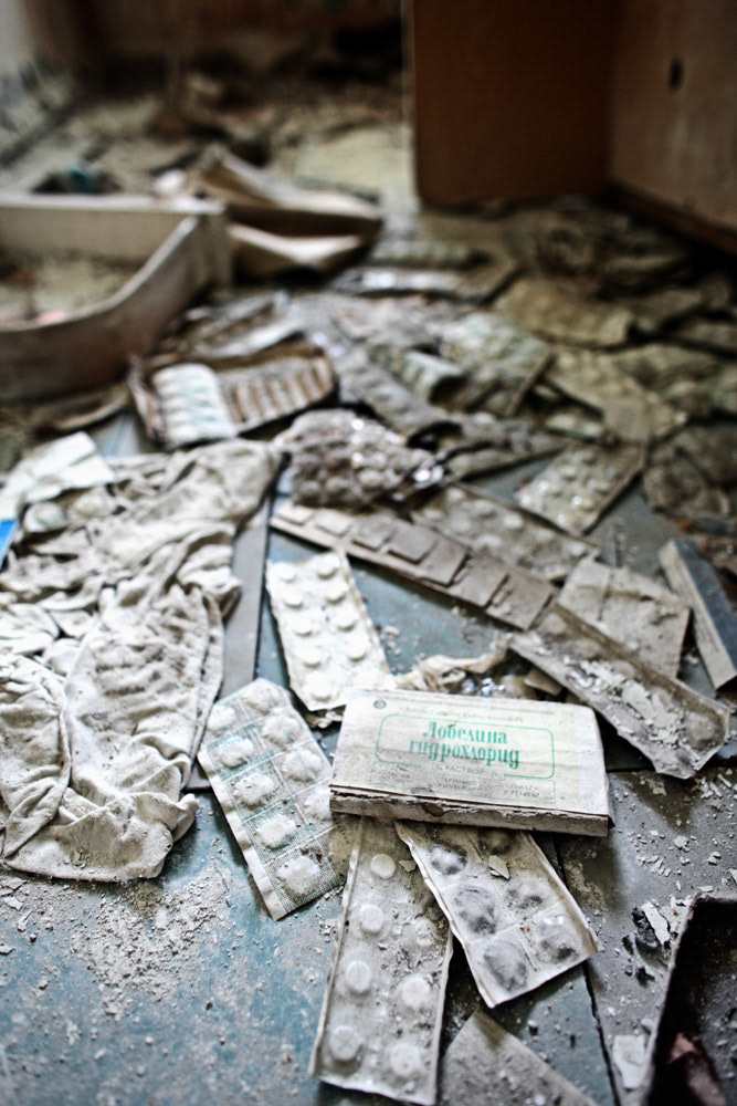 A lot of pills are strewn on a floor at a kindergarten dispensary, Pripyat.