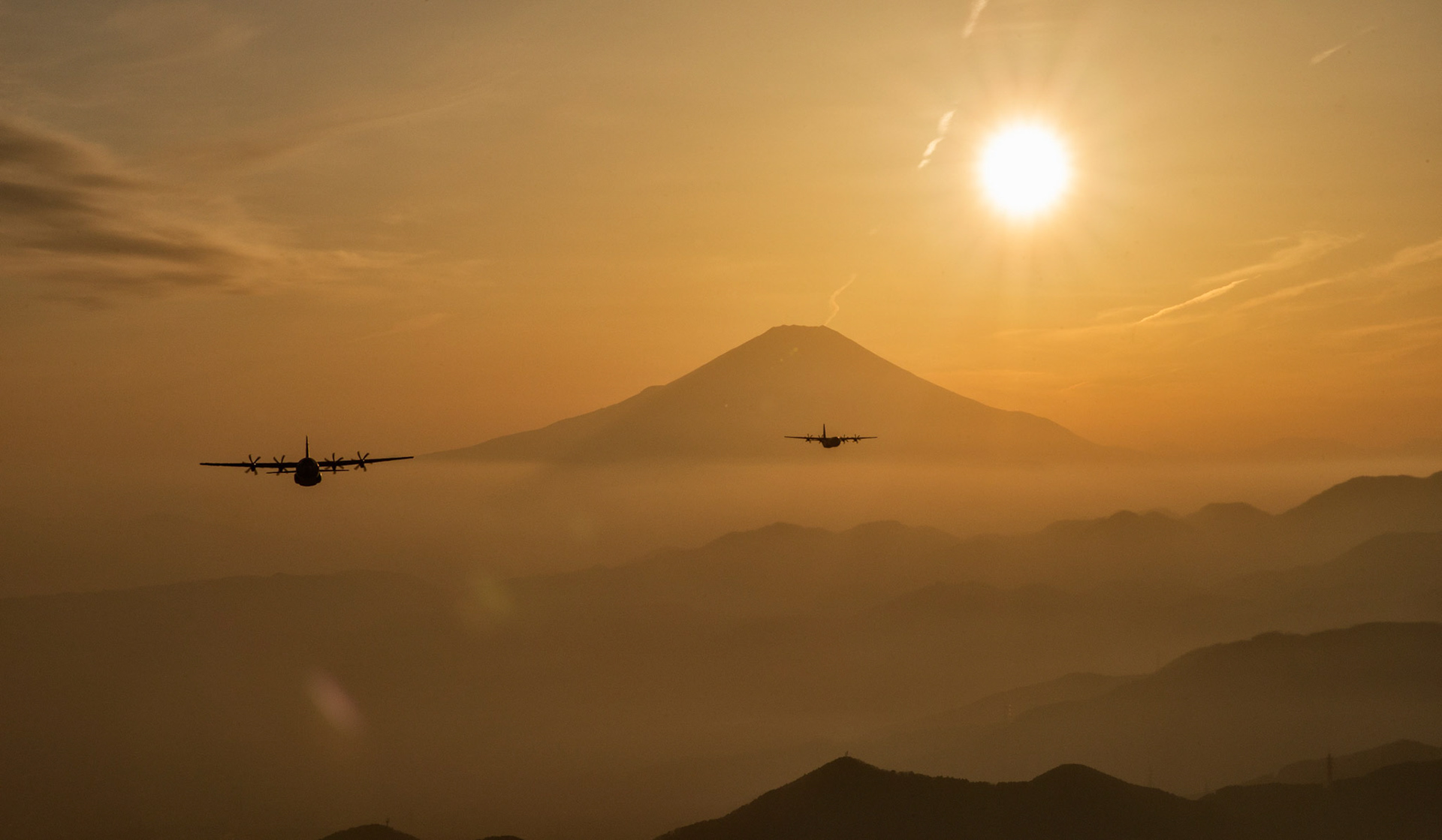 Two Air Force C-130J Super Hercules fly over Yamanashi Prefecture, Japan, after conducting airdrop training missions, March 26, 2018. The C-130J assigned to the 36th Airlift Squadron regularly conducts training missions to remain proficient in necessary skills to support any contingency. (U.S. Air Force photo by Yasuo Osakabe)