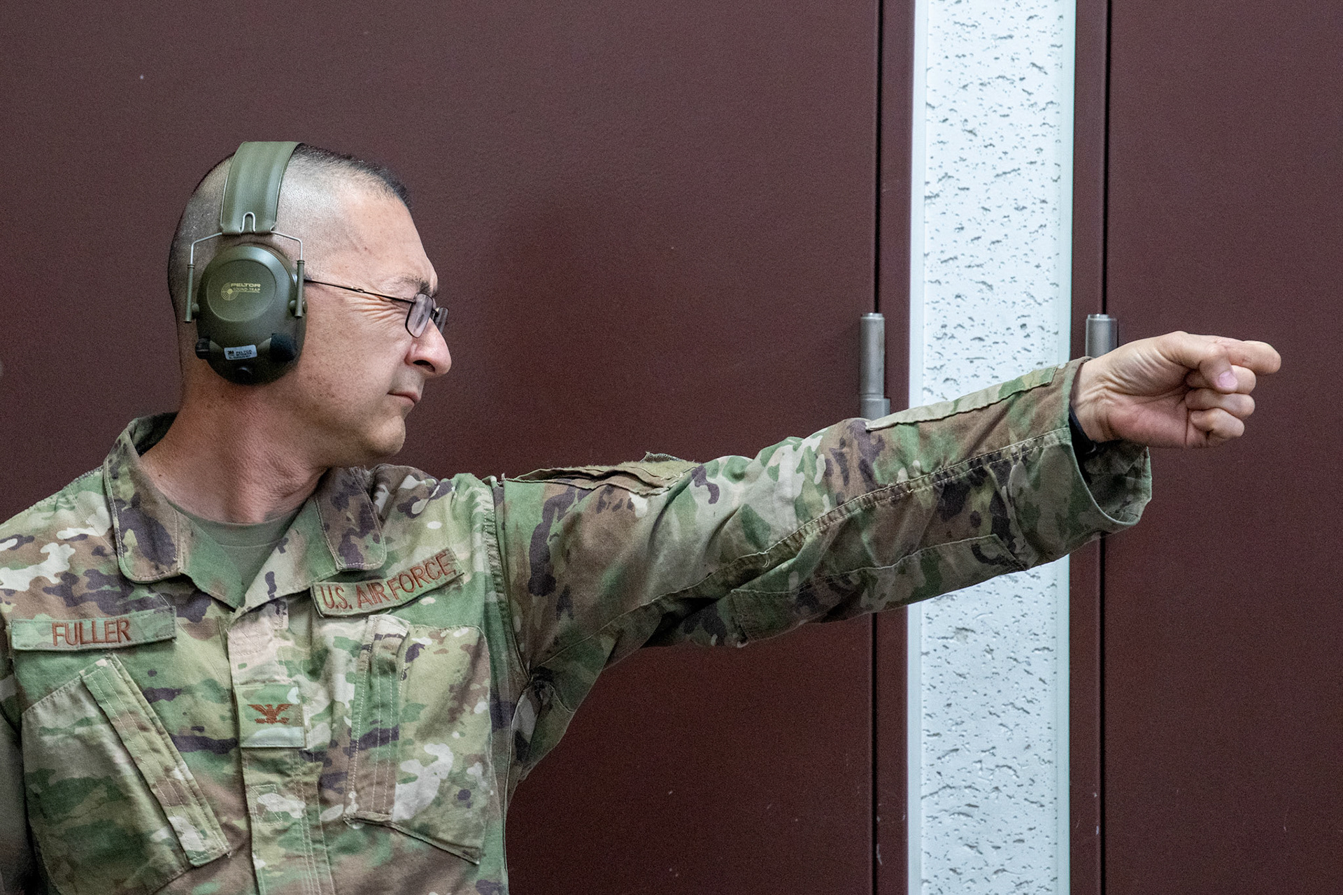 Col. Christopher Fuller, 5th Air Force, visualizes the distance between himself and the target during an Excellent-In-Competition M9 Beretta pistol event at Yokota Air Base, Japan, April 12, 2022. The four-day competition was held to boost morale and test 165 active-duty military members on how accurate they can shoot their authorized duty pistols. The top 10% scorers will earn the Air Force Excellence In Competition medal to wear on the Service Dress Uniform. (U.S. Air Force photo by Yasuo Osakabe)