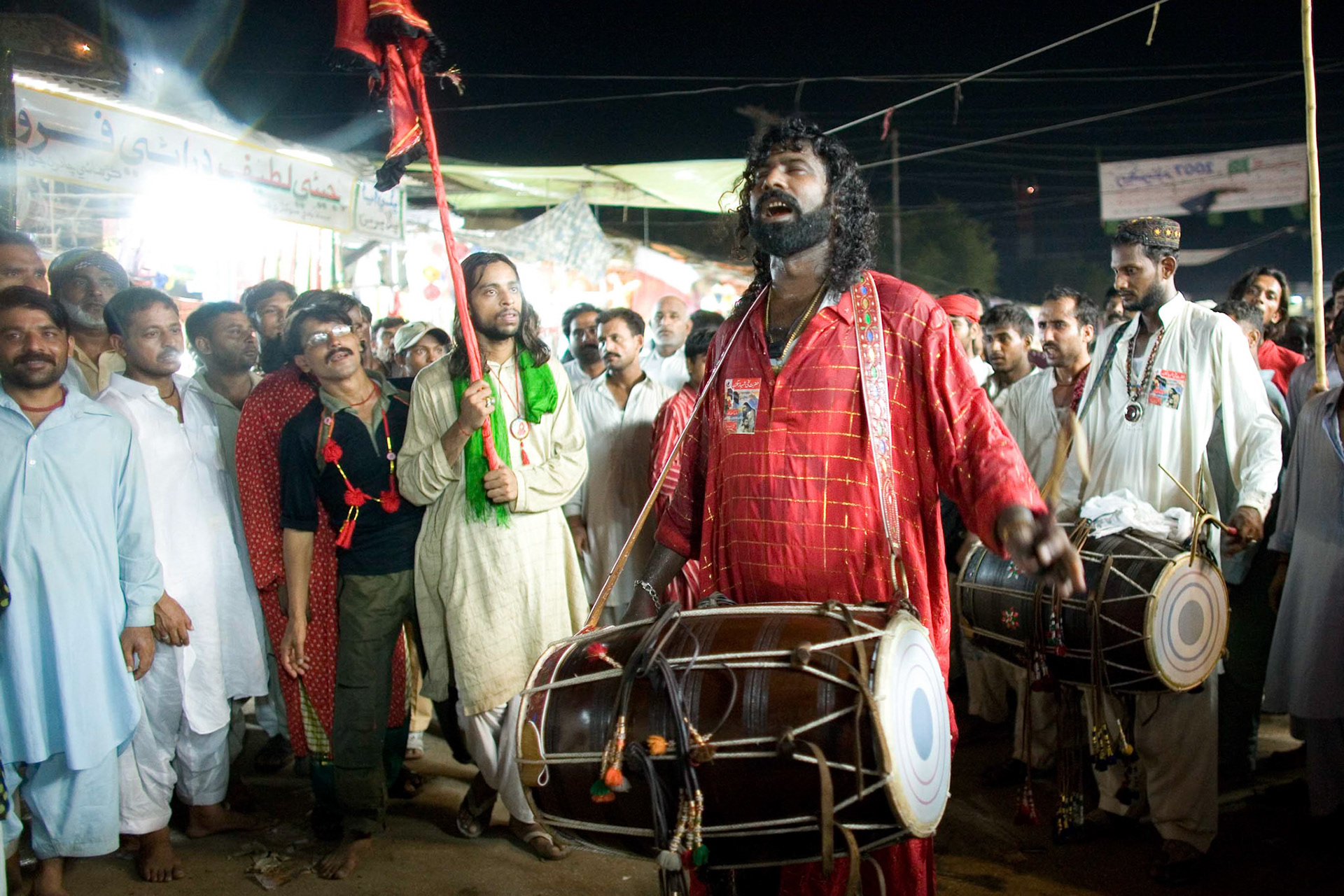 Gonga sain (centre) and Mithu sain (back) played the dhol for dedicating their sufi beat and devotee's prayer to the great sufi saint, Hazrat Lal Shahbaz Qalandar by the shrine. (Travel)