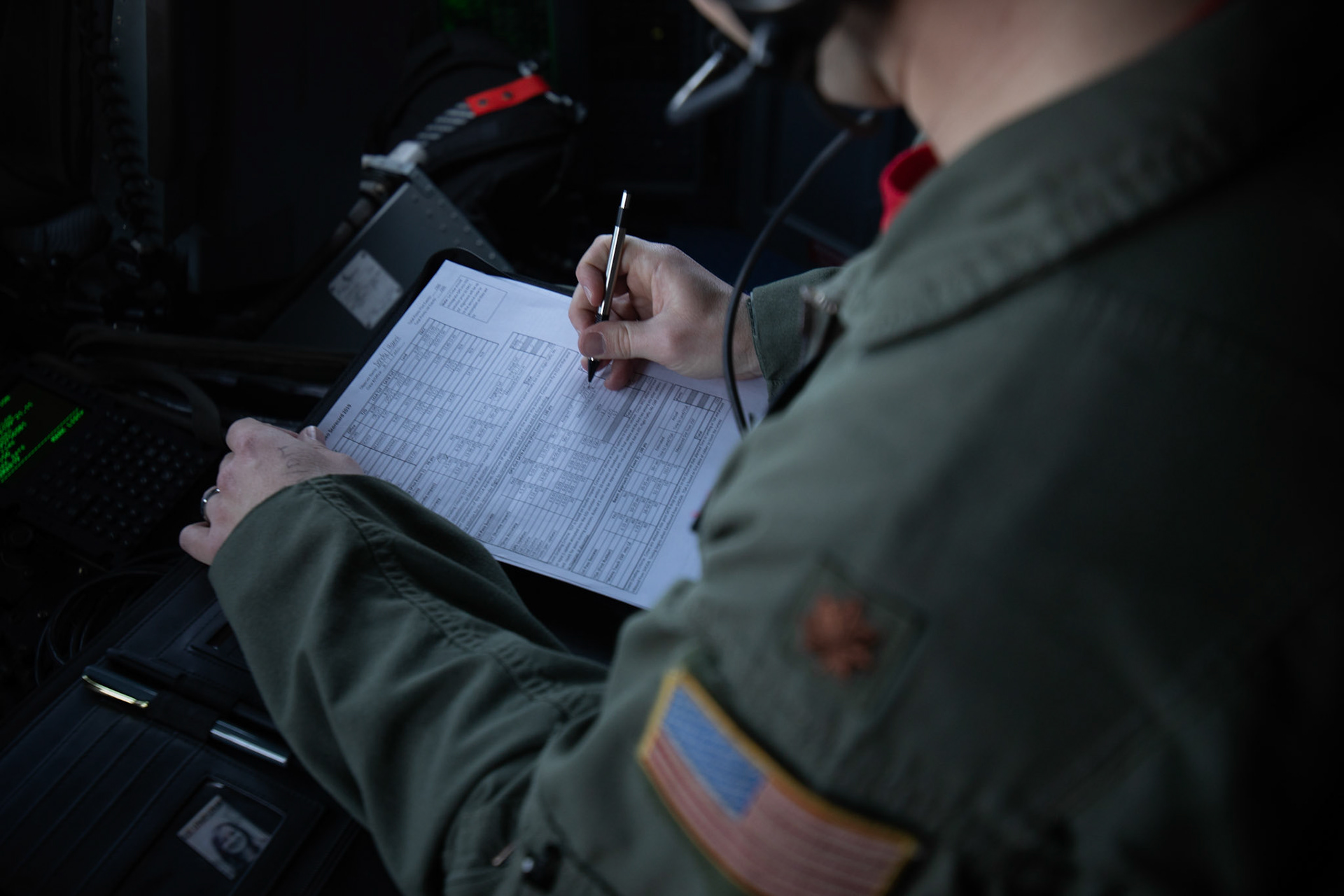 Maj. Brian Dendy, 36th Airlift Squadron assistant director operations, writes a score on a judging sheet during the Yokota C-130J Rodeo over the Kanto Plain, March 22, 2019. The 36th Airlift Squadron held a tactical airlift Rodeo competition to test and improve combat tactics in a competitive environment with a split focus on pilot and loadmaster skills. (U.S. Air Force photo by Yasuo Osakabe)