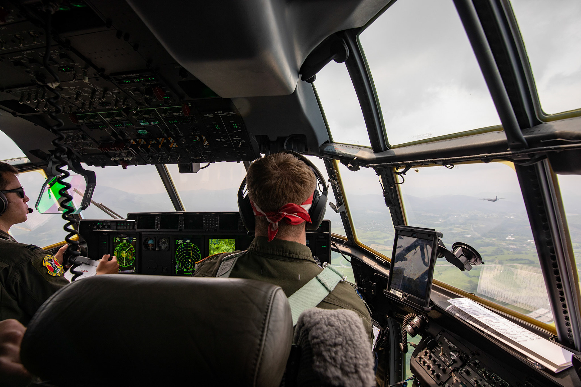 (Left to right) U.S. Air Force Capt. Evan Taylor and Capt. Michael Pyles, 36th Airlift Squadron pilots, conduct training over Mount Aso, Japan, July 16, 2019, during a bilateral jump training. The training allows USAF and JGSDF units to work alongside each other while improving the readiness of our armed forces. (U.S. Air Force photo by Yasuo Osakabe)