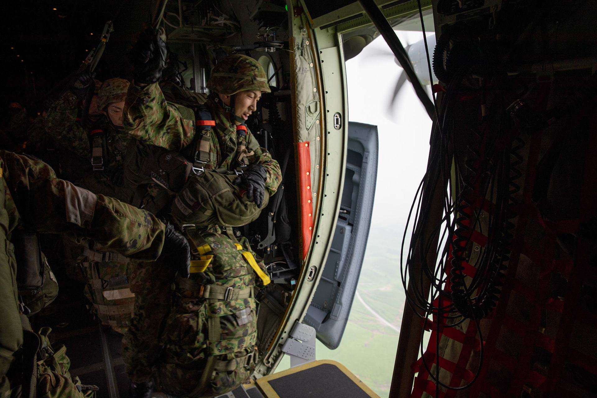 A Japan Ground Self-Defense Force soldier assigned to the 1st Airborne Brigade is ready to jump from a U.S. Air Force C-130J Super Hercules from the 36th Airlift Squadron over Hiju-dai exercise area, Oita prefecture, Japan, July 16, 2019, during a bilateral jump training. The training allows USAF and JGSDF units to work alongside each other while improving the readiness of our armed forces. (U.S. Air Force photo by Yasuo Osakabe)