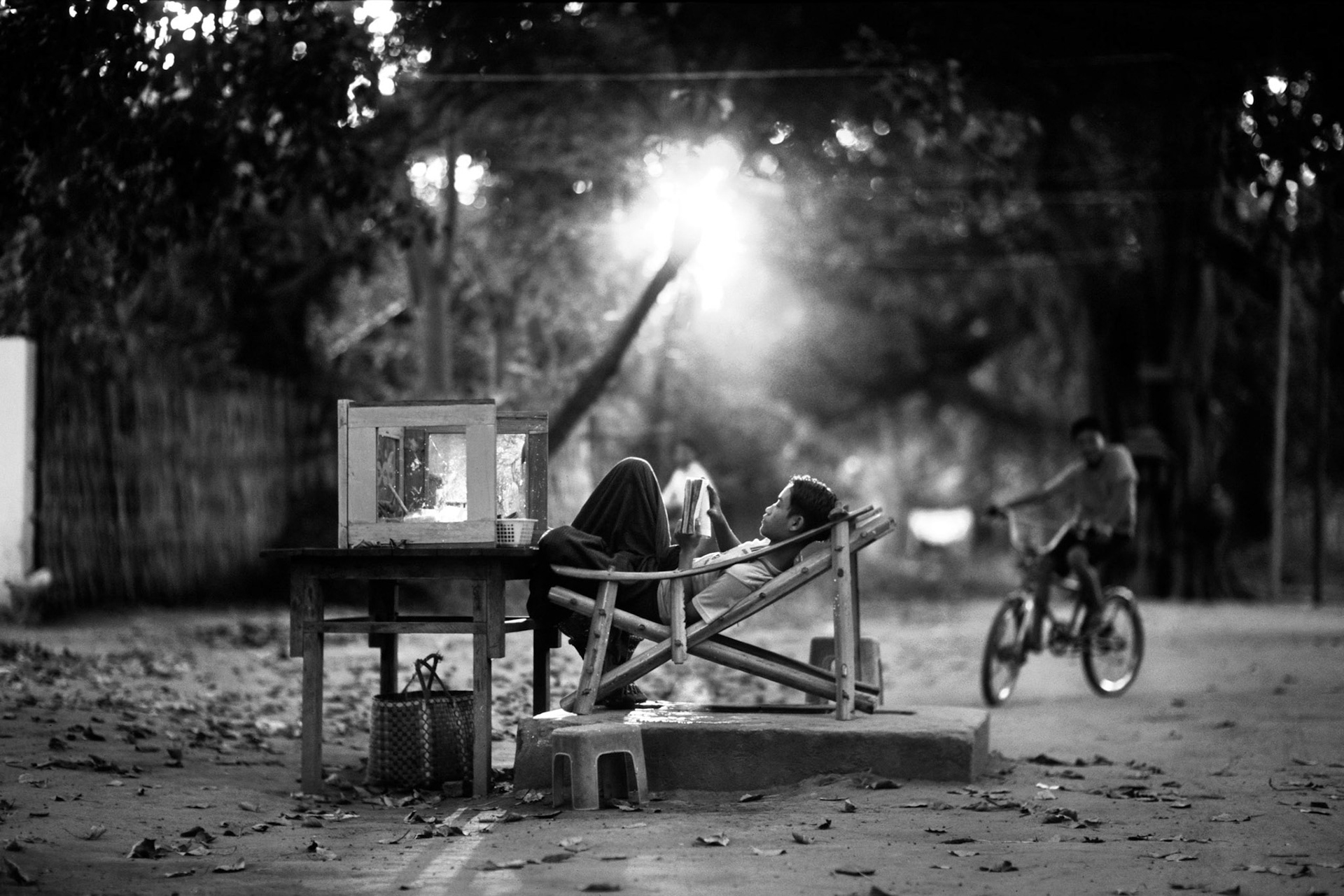 A young boy finishes the job at his own small Paan shop at Bagan, Myanmar, Oct. 2002. Paan is a stimulating and psychoactive preparation of betel leaf combined with areca  nut and cured tobacco.  (Photo by Osakabe Yasuo)