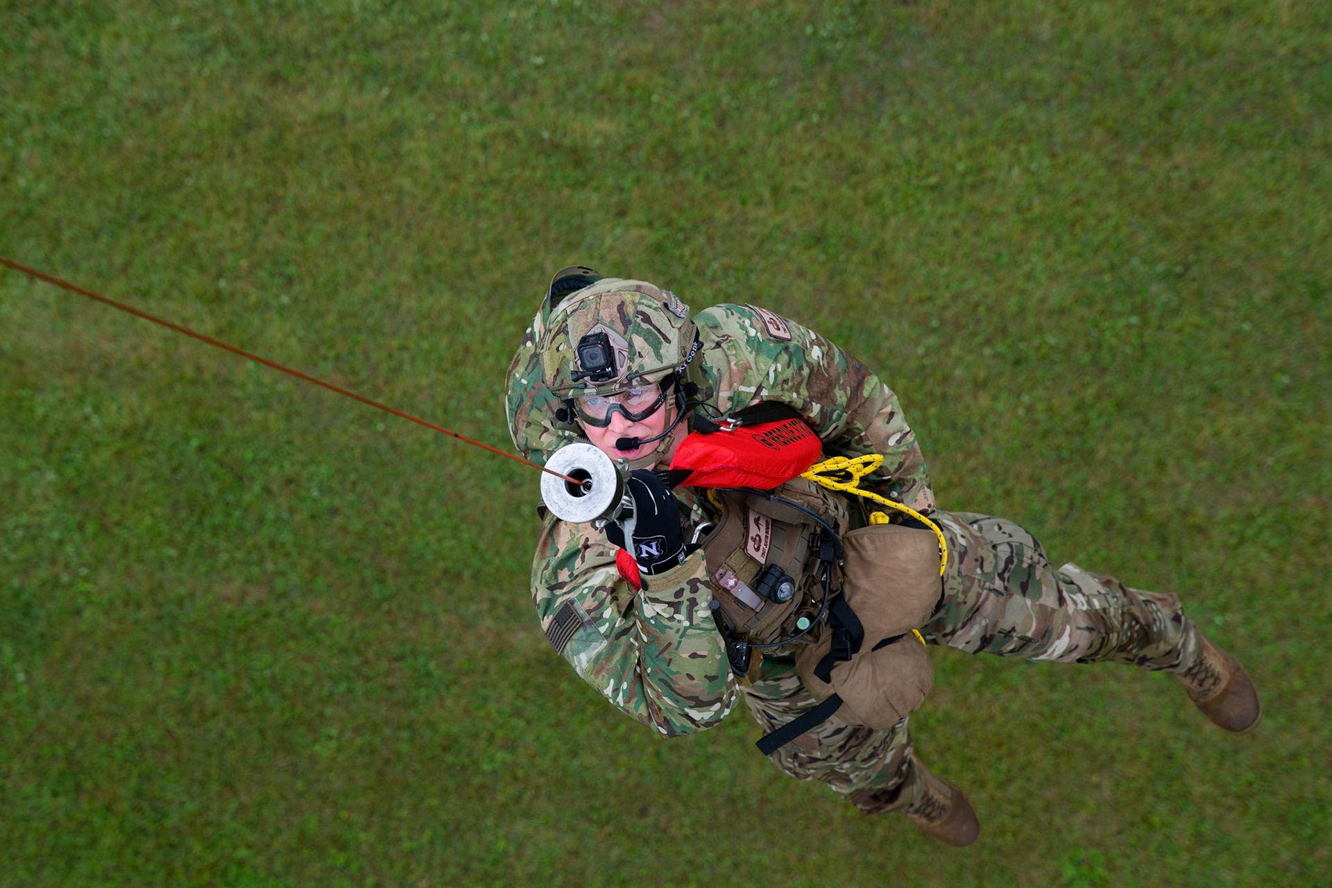Tech. Sgt. Justin Bender, 374th Operations Support Squadron survival, evasion, resistance and escape specialist, is hoisted into a UH-1N Iroquois during a Capabilities Exercise as part of the 2018 Japanese-American Friendship Festival at Yokota Air Base, Japan, Sept. 15, 2018. Members with the 459th AS showcased their rescue capabilities to execute search-and-rescue mission. (U.S. Air Force photo by Yasuo Osakabe)
