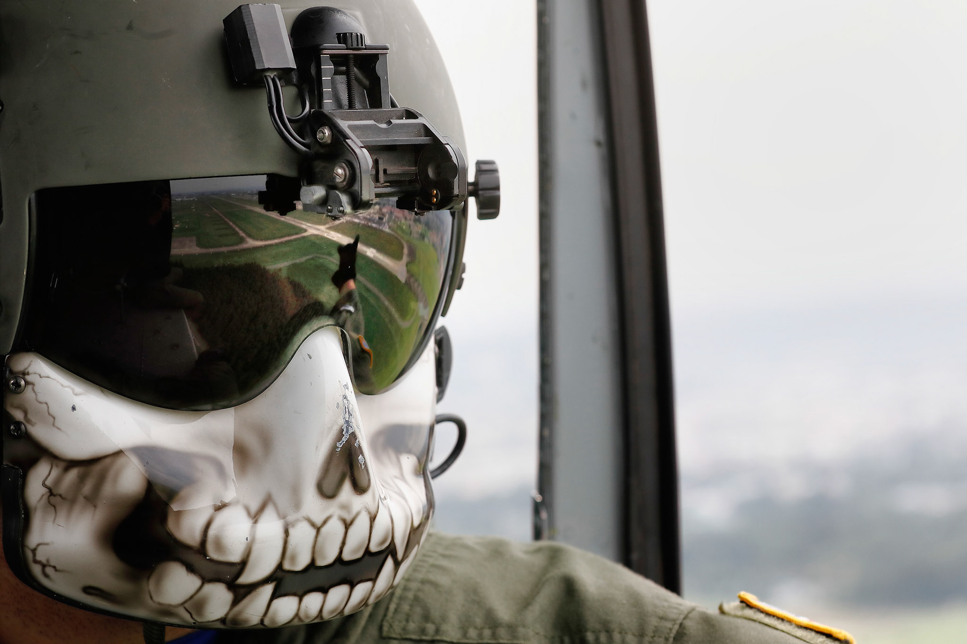 Tech. Sgt. Christopher Rector, 459th Airlift Squadron UN-1N Iroquois flight engineer, performs visual conformation over Yokota Air Base, Japan, Sept. 17, 2016, during the 2016 Japanese-American Friendship Festival. The 459 AS demonstrated their airlift capabilities to festivalgoers. Yokota welcomed over 135,000 visitors for the festival. (U.S. Air Force photo by Yasuo Osakabe/Released)