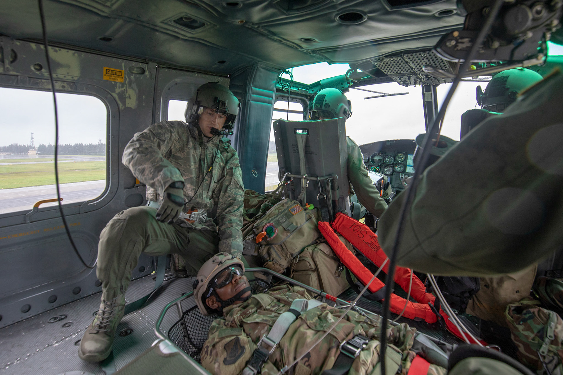 Tech. Sgt. Dustin Sheffield, 459th Airlift Squadron UH-1N standardized and evaluation flight engineer, loads a simulated victim into a UH-1N Iroquois during a Capabilities Exercise as part of the 2018 Japanese-American Friendship Festival at Yokota Air Base, Japan, Sept. 15, 2018. Members with the 459th AS showcased their rescue capabilities to execute search-and-rescue mission. (U.S. Air Force photo by Yasuo Osakabe)
