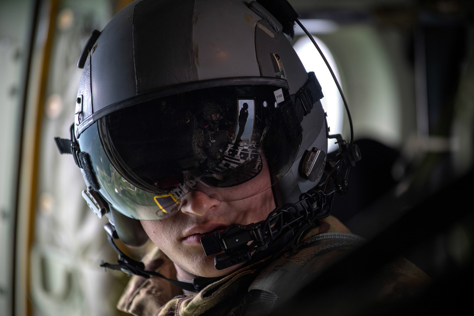 U.S. Air Force Senior Airman William Griffin, 36th Airlift Squadron loadmaster, communicates with his crewmembers over Hiju-dai exercise area, Oita prefecture, Japan, July 16, 2019, during a bilateral jump training. The training allows USAF and JGSDF units to work alongside each while improving the readiness of our armed forces. (U.S. Air Force photo by Yasuo Osakabe)