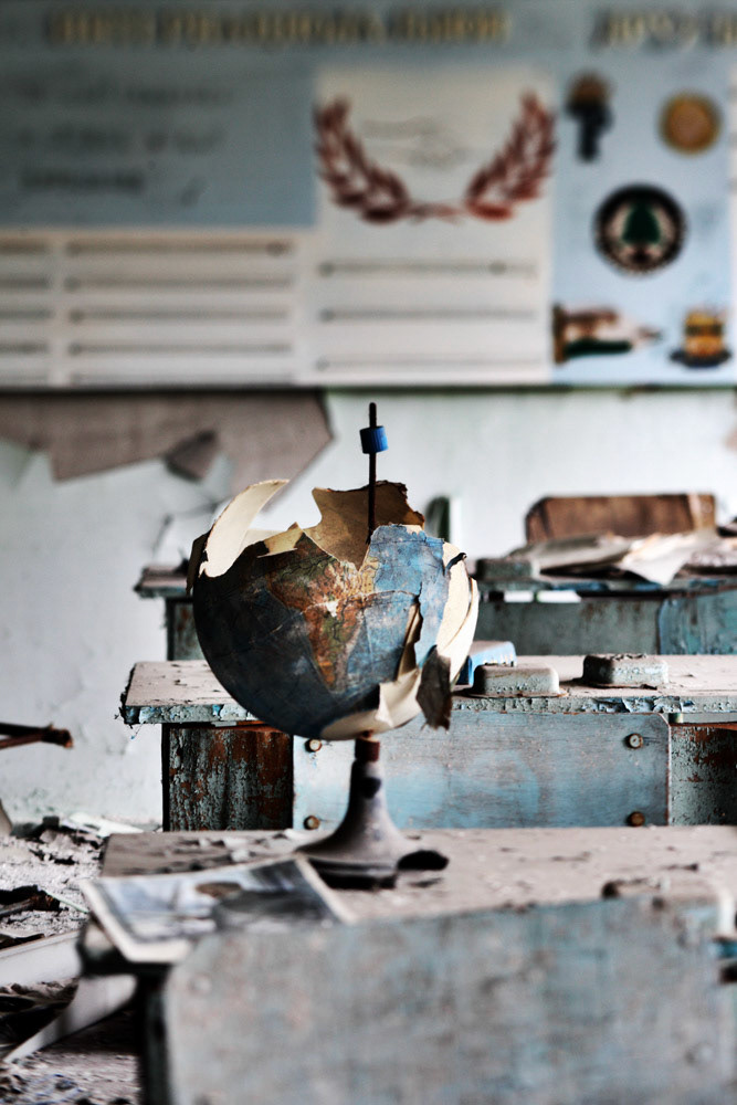 A globe for which only the southern hemisphere is left has been sit on a desk at the school, Pripyat. It seems like the the collapse of the Soviet Union.