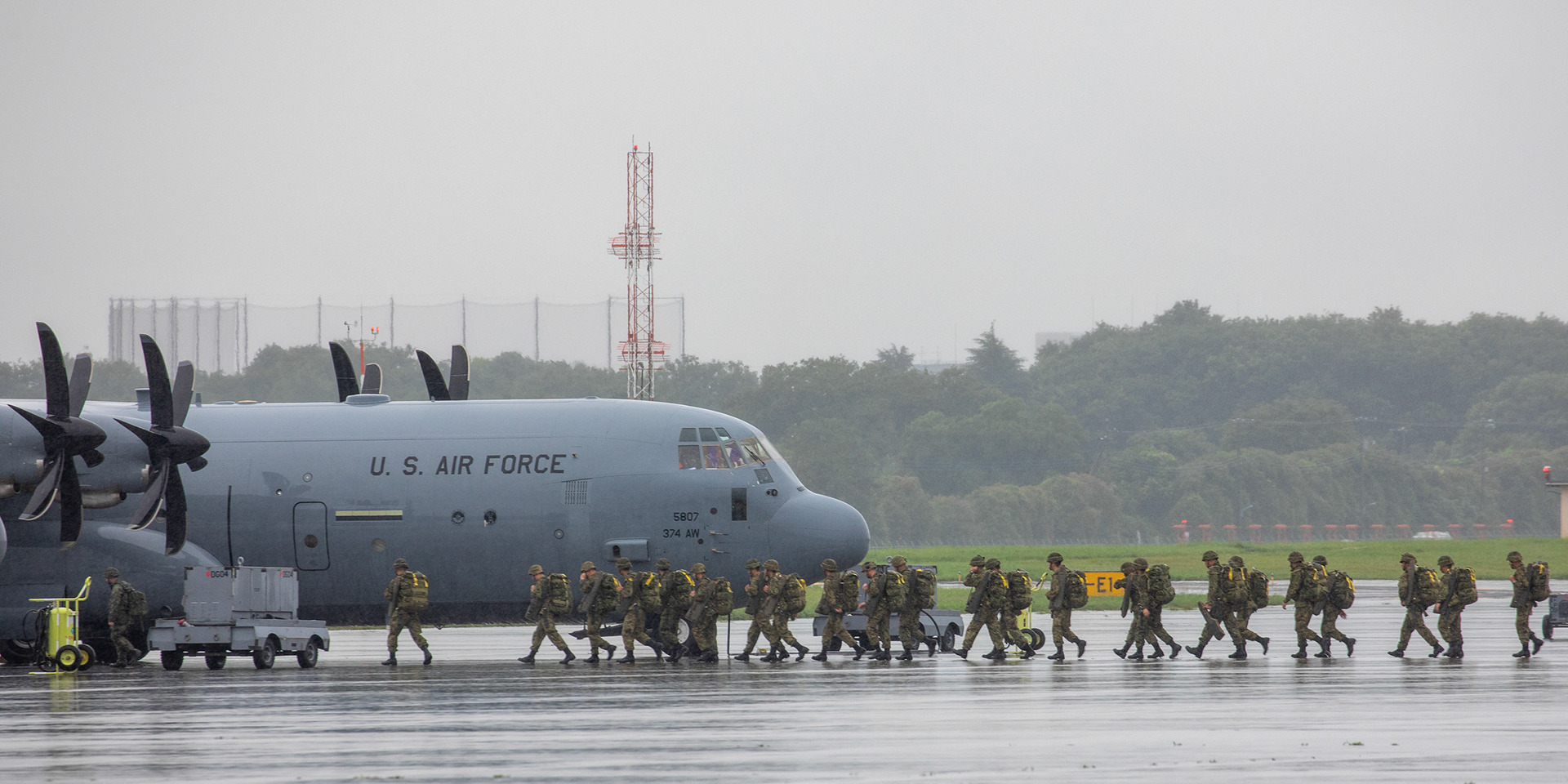 Japan Ground Self-Defense Force soldiers with the 1st Airborne Brigade board a U.S. Air Force C-130J Super Hercules assigned to the 36th Airlift Squadron at Yokota Air Base, Japan, July 16, 2019, during a bilateral jump training. The training allows USAF and JGSDF units to work alongside each other while improving the readiness of our armed forces. (U.S. Air Force photo by Yasuo Osakabe)