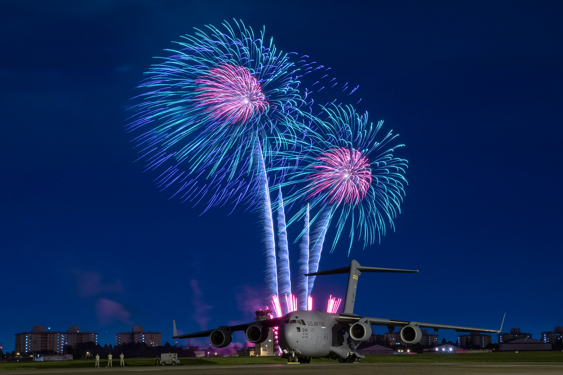 Fireworks explode behind a U.S. Air Force C-17 Globemaster III aircraft assigned to the 15th Wing during Celebrate America, July 3, 2018, at Yokota Air Base, Japan. Celebrate America is an annual event that provides military members and their families the opportunity to enjoy games, food and bands before culminating in a fireworks display over the Yokota AB airfield to celebrate Independence Day. (U.S. Air Force photo by Yasuo Osakabe)
