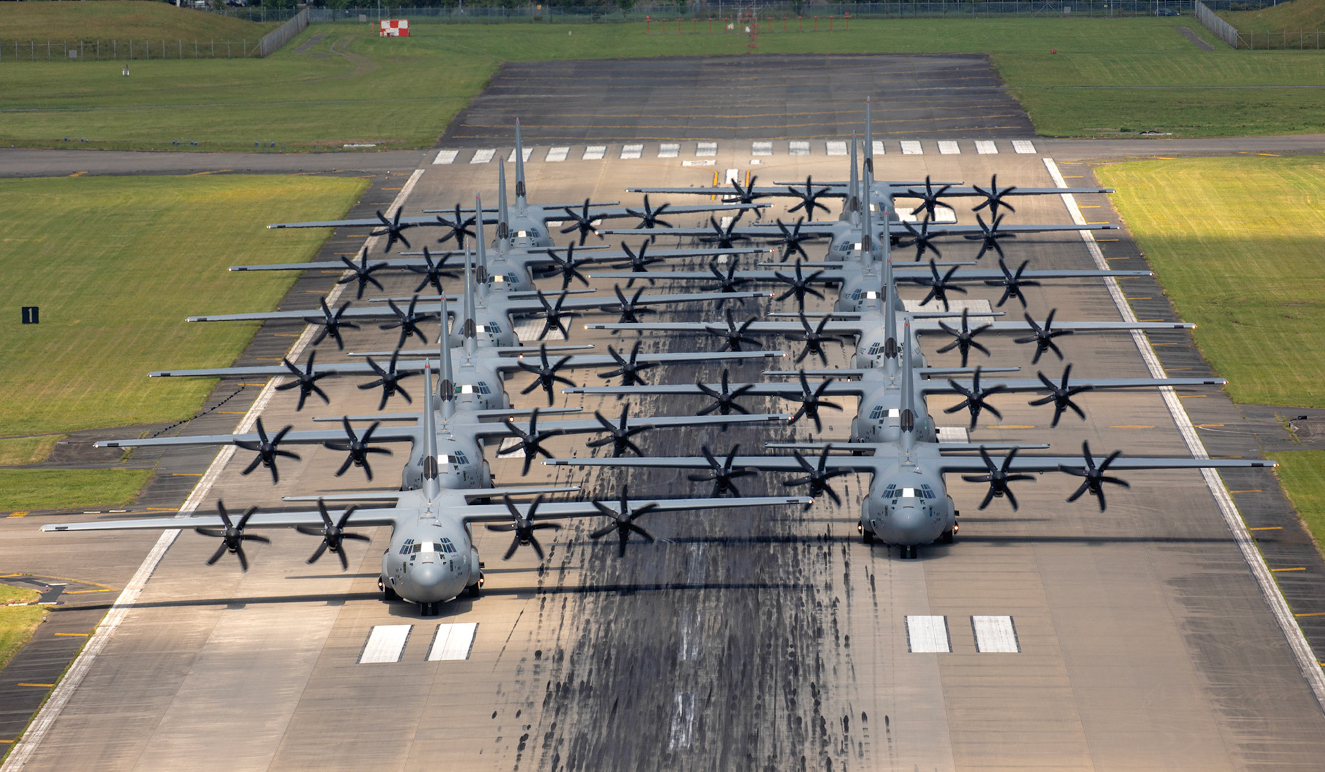 Twelve C-130J Super Hercules perform an Elephant Walk as part of the 374th Airlift Wing (AW) Generation Exercise to test the rapid mobility capabilities and teamwork of the crewmembers at Yokota Air Base, Japan, May 4, 2018. The 374th AW maintains and operates the C-130J Super Hercules, C-12 Huron, and UH-1N Iroquois, making it the primary Western Pacific airlift hub for U.S. Air Force peacetime and contingency operations. (U.S. Air Force photo by Yasuo Osakabe)