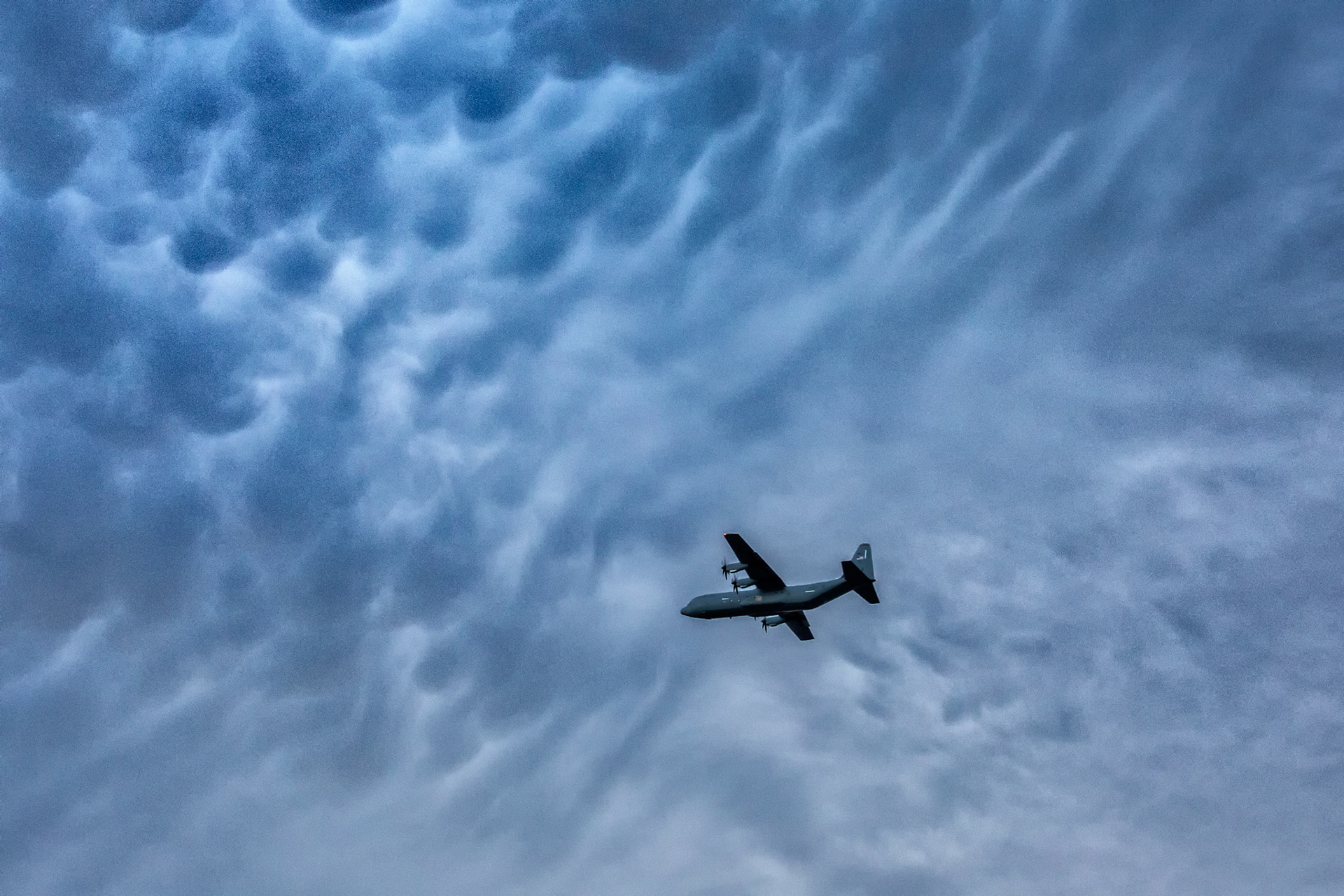 A U.S. Air Force C-130J Super Hercules aircraft flies under mammatus clouds at Yokota Air Base, Japan, June 27, 2018, during a training mission. Mammatus clouds form as moist warm air rises and meets cooler air to form pockets of clouds. (U.S. Air Force photo by Yasuo Osakabe)