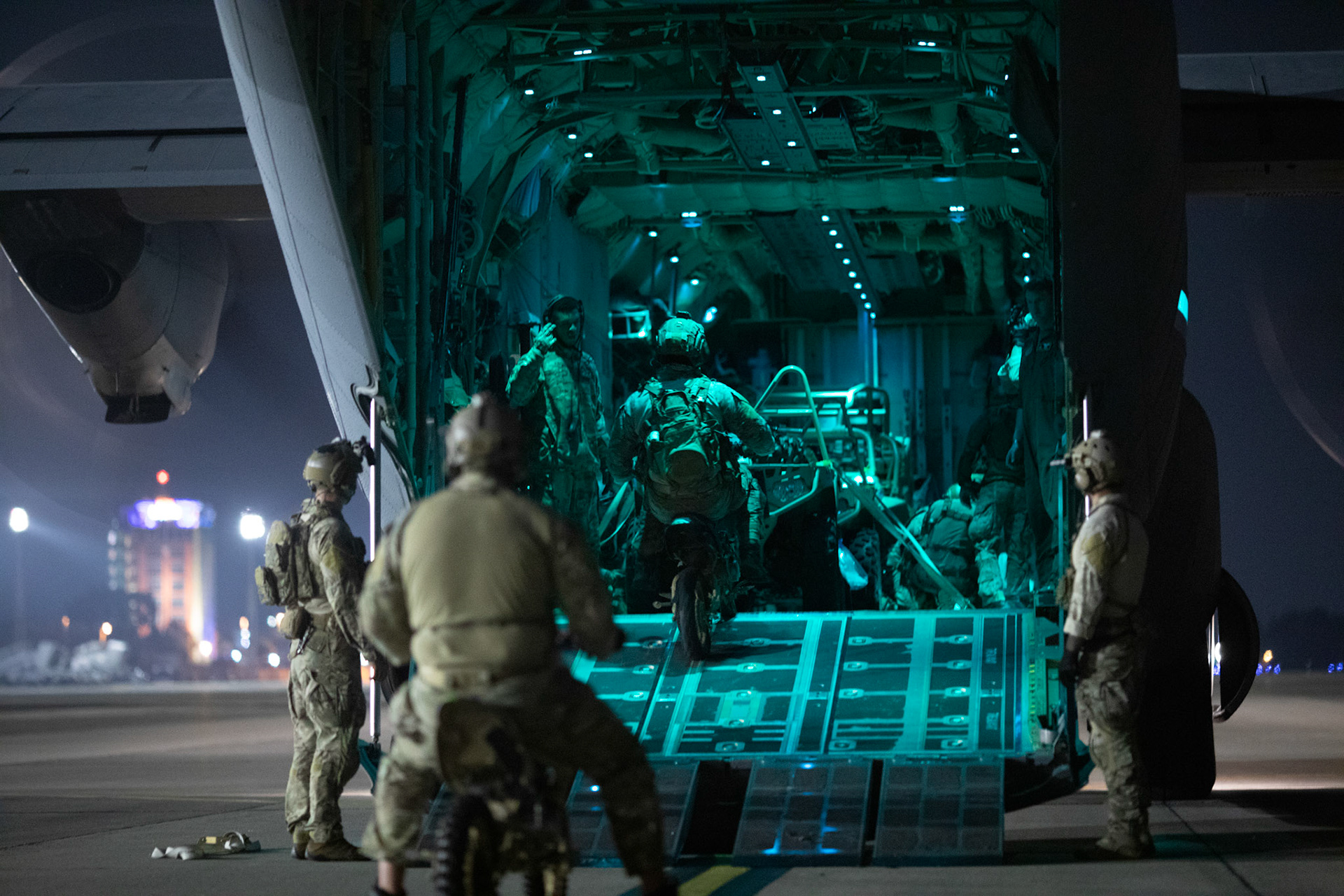 U.S. Air Force Special Tactics operators with the 320th Special Tactics Squadron out of Kadena Air Base, Japan, wait to load their tactical vehicles into a C-130J Super Hercules during an engine running onload/offload (ERO) training as part of Exercise Gryphon Jet at Yokota Air Base, Japan, June 23, 2020. Special Tactics is a U.S. Special Operation Command's tactical air and ground integration force, and the Air Force's special operations ground force, leading Global Access, Precision Strike, Personnel Recovery and Battlefield Surgery operations on the battlefield. The Exercise Gryphon Jet is an integrated training exercise focused on improving interoperability throughout the special operations community. (U.S. Air Force photo by Yasuo Osakabe)