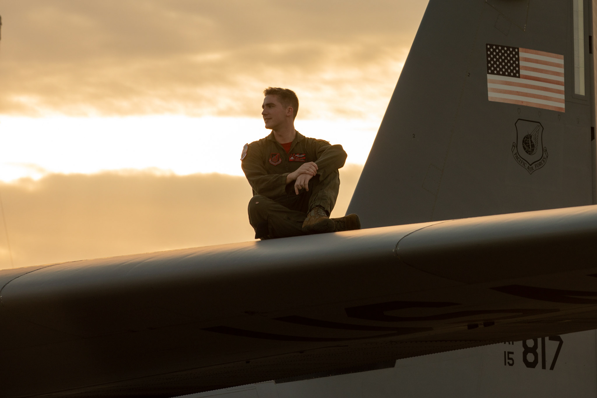 An Airman with the 36th Airlift Squadron sits on the wing of a C-130J Super Hercules during the 2019 Japanese-American Friendship Festival at Yokota Air Base, Japan, Sept. 14, 2019. The festival gives community members a chance to come onto Yokota to see static aircraft, witness military demonstrations, learn about the capabilities and training done at Yokota and to meet with the service members who work and live on base. (U.S. Air Force photo by Yasuo Osakabe)