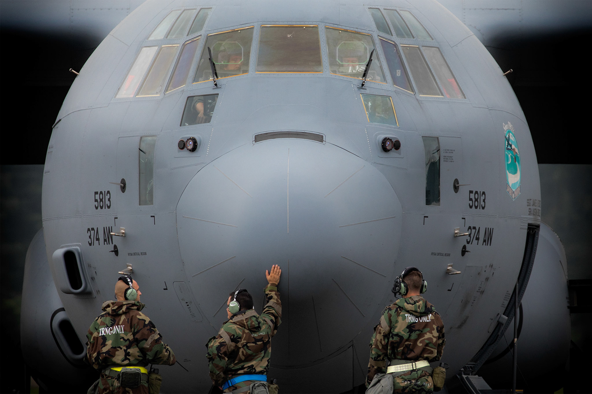 Crew chiefs from the 374th Aircraft Maintenance Squadron await a C-130J Super Hercules engine to start during Exercise Beverly Morning 17-05 at Yokota Air Base, Japan, Aug. 18, 2017. The training is designed to test the ability of Airmen to survive in austere environments with chemical, biological, radiological, nuclear and explosive hazards. (U.S. Air Force photo by Yasuo Osakabe)