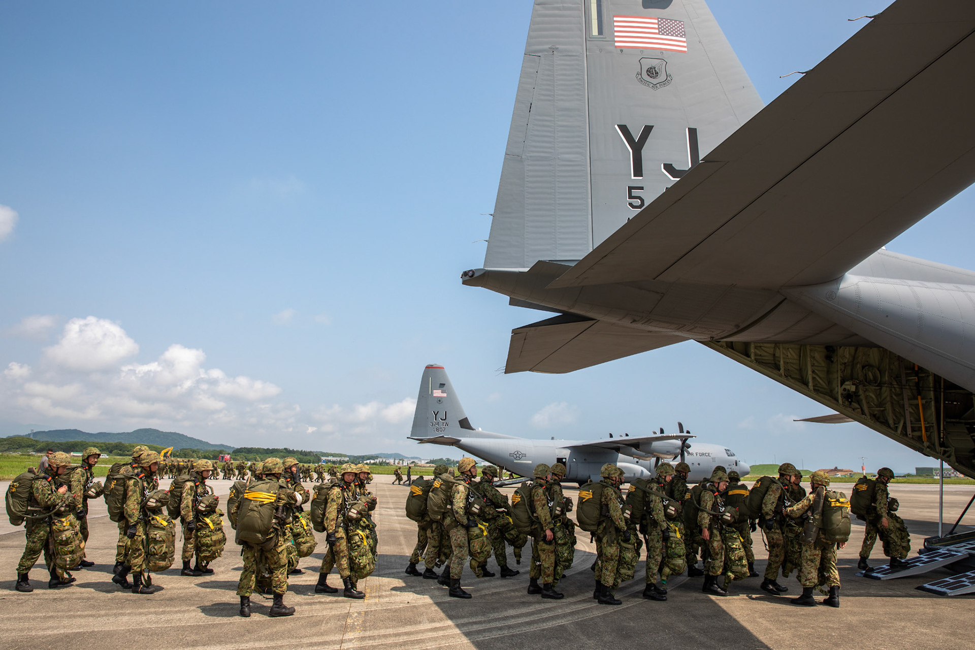Japan Ground Self-Defense Force soldiers assigned to the 1st Airborne Brigade board a U.S. Air Force C-130J Super Hercules assigned to the 36th Airlift Squadron at Japan Air Self-Defense Force Tsuiki Air Base, Japan, July 16, 2019, during a bilateral jump training. The training allows USAF and JGSDF units to work alongside each other while improving the readiness of our armed forces. (U.S. Air Force photo by Yasuo Osakabe)