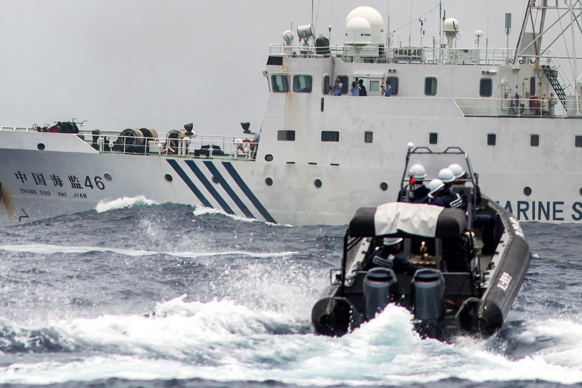 ENKAKU ISLANDS, Japan -- A patrol boat form the Japanese Coast Guard observe the Chinese maritime surveillance ship Haijian NO. 46 for protect Japanese commercial boats, May 26, 2013 at Uotsuri-jima, Japan. Chinese government ships entered into the Japanese territorial waters of 46 times. (Photo by Osakabe Yasuo)