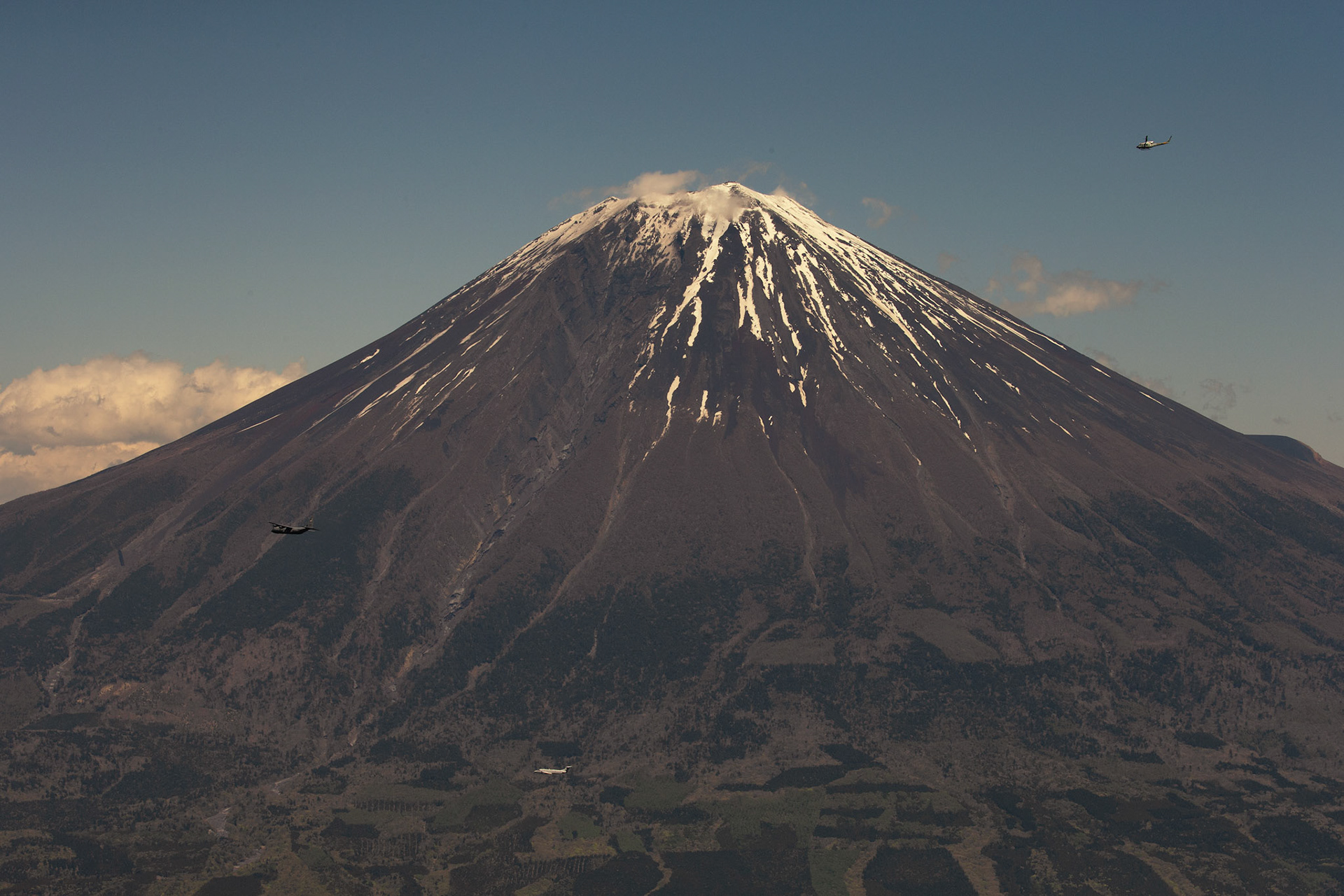 Aircraft from the 374th Airlift Wing (AW) fly by Mount Fuji, Japan, during the 374th AW Generation Exercise, May 4, 2018. The 374th AW maintains and operates the C-130J Super Hercules, C-12 Huron, and UH-1N Iroquois, making it the primary Western Pacific airlift hub for U.S. Air Forces during peacetime and contingency operations. (U.S. Air Force photo by Yasuo Osakabe)