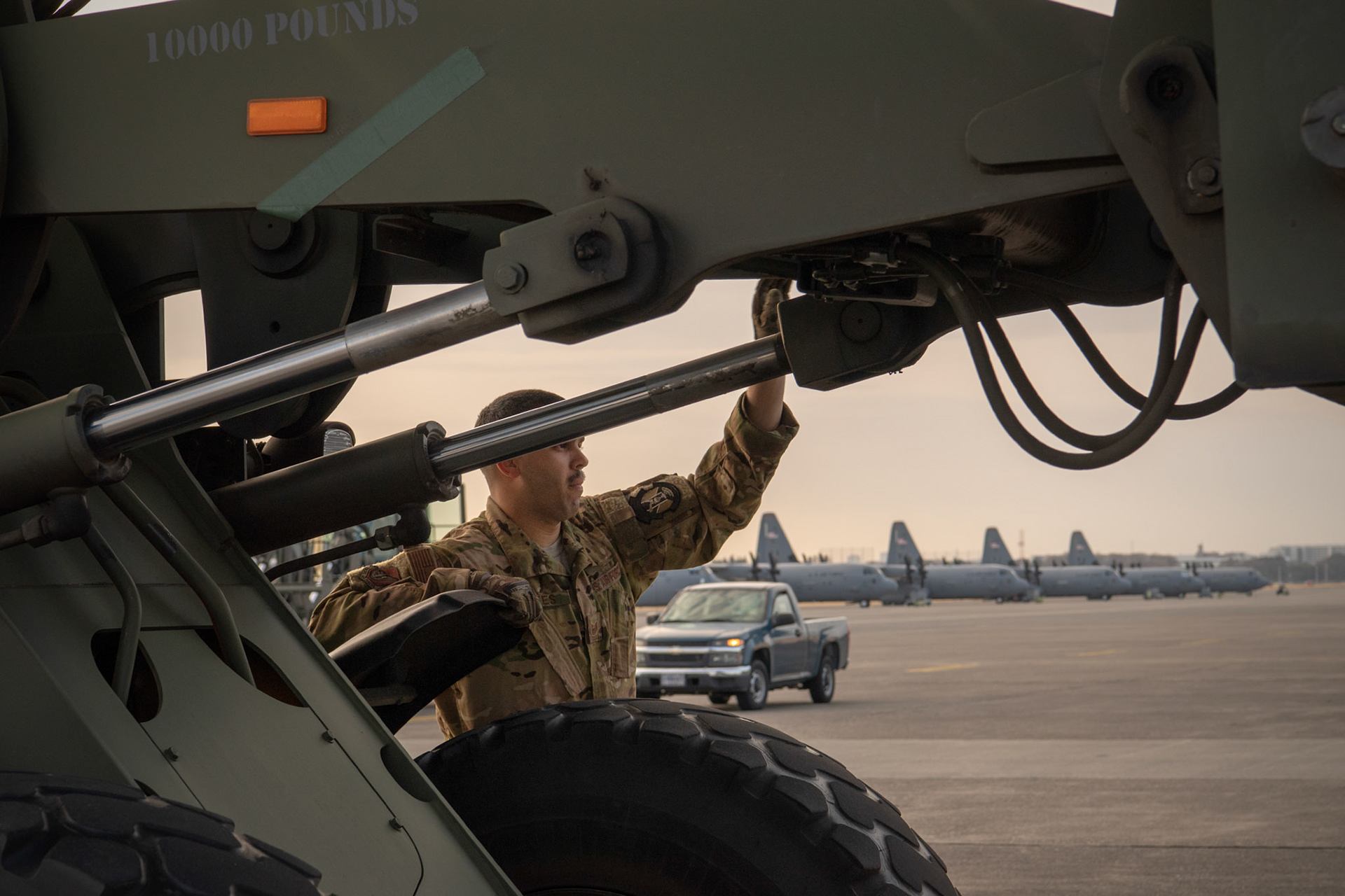 Tech. Sgt. Brian Gates, 36th Airlift Squadron C-130J loadmaster, marshals a forklift during the Yokota C-130J Rodeo at Yokota Air Base, Japan, March 22, 2019. The Rodeo is a tactical airlift competition between flights within the 36th Airlift Squadron and 374th Operations Support Squadron, whose goal is to demonstrate capabilities, improve procedures, and enhance standardization for global operations.  (U.S. Air Force photo by Yasuo Osakabe)