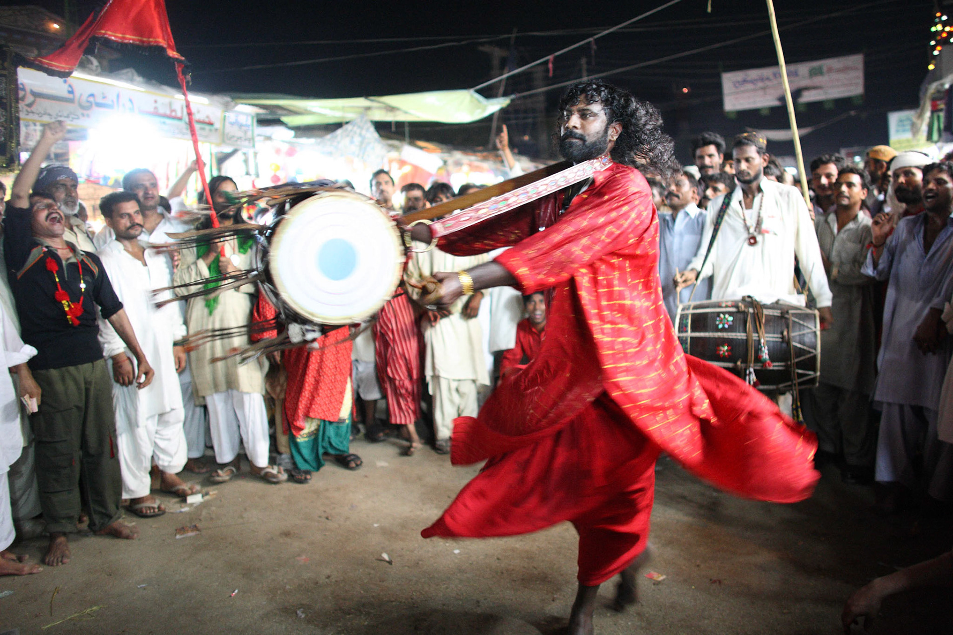 The most exciting moments had come when Gonga sain (centre) had revolved ceaselessly his dhol in the air. Devotees had been shouted Mast Qalandar in trance. (Travel)