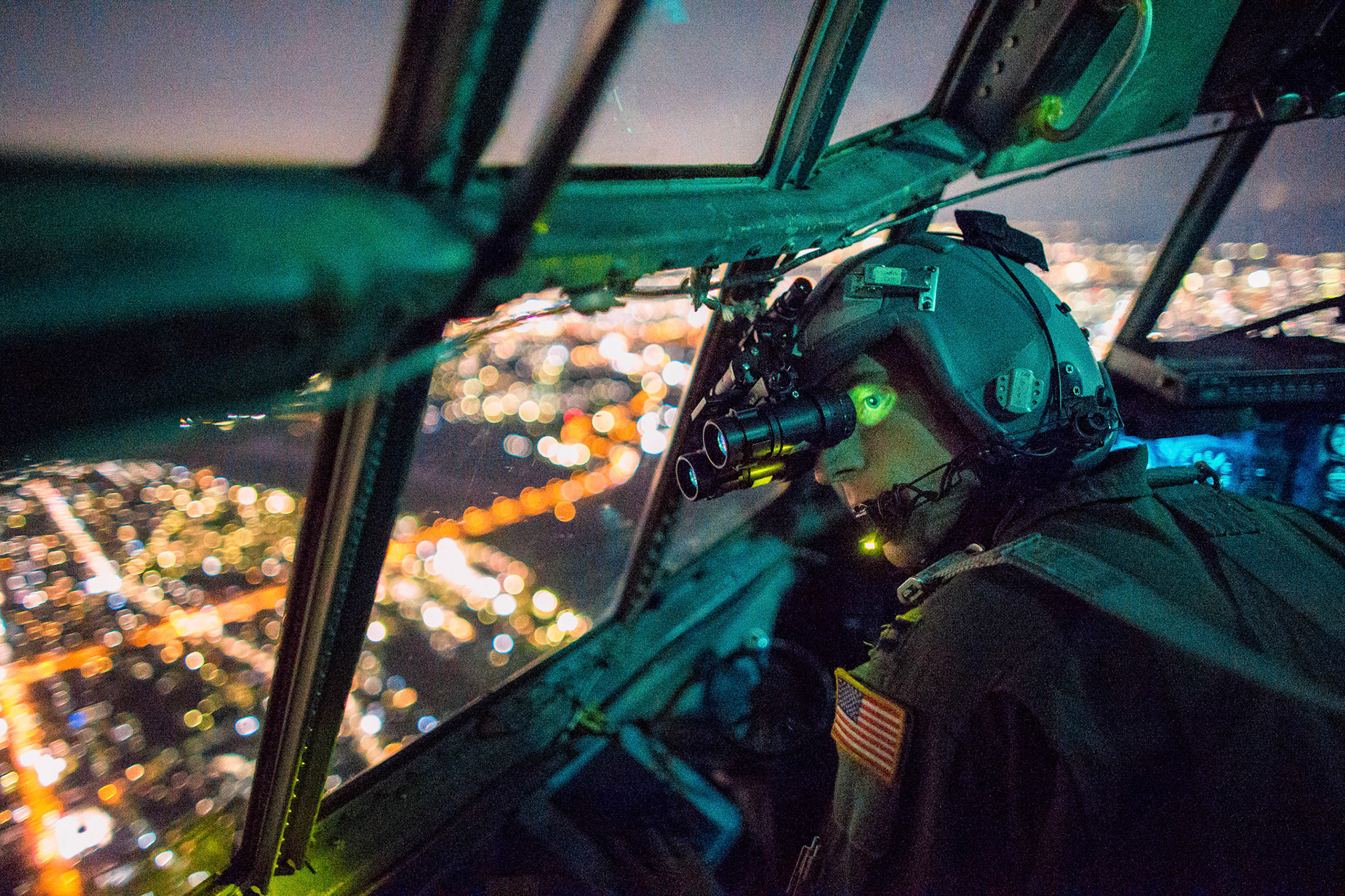 Capt. Thomas Bernard, 36th Airlift Squadron C-130 Hercules pilot, performs a visual confirmation with a night vision goggles during a training mission over the Kanto Plain, Japan, Oct. 14, 2015. Yokota aircrews regularly conduct night flying operations to ensure they’re prepared to respond to a variety of contingencies throughout the Indo-Asia Pacific region. (U.S. Air Force photo by Osakabe Yasuo/Released)