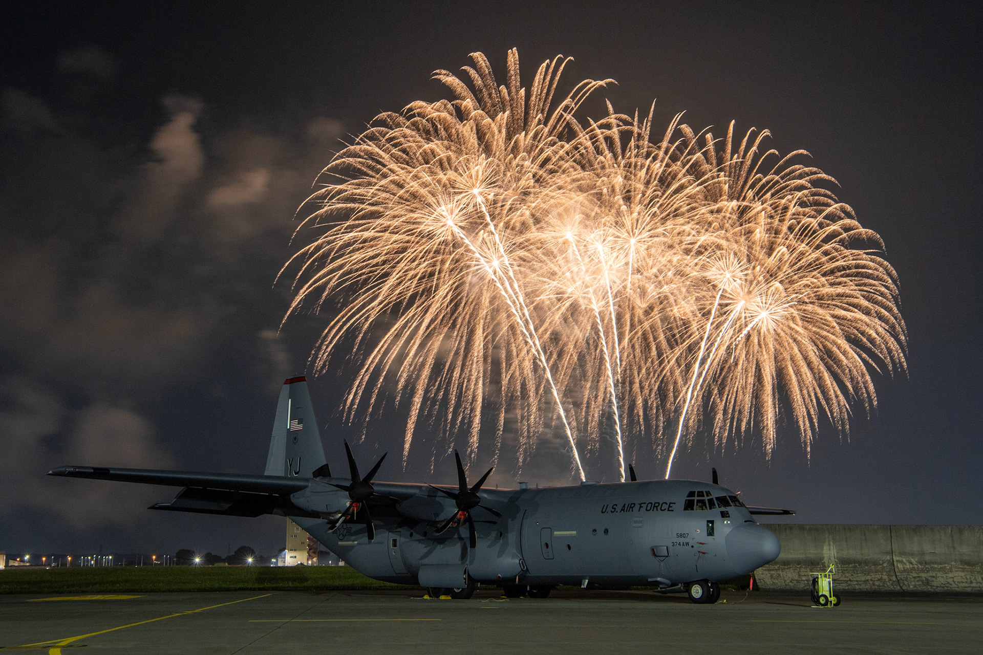 A U.S. Air Force C-130J Super Hercules assigned to the 36th Airlift Squadron sits on the flightline at Yokota Air Base, Japan, May 21, 2023 during the Japanese-American Friendship Festival fireworks display. The two-day festival allowed visitors to learn more about the U.S. and Japan bilateral partnership while strengthening the bonds between Yokota and the local communities. Yokota was able to host the event with the support of the Japan Self-Defense Force, sister services, and the local community. (U.S. Air Force photo by Yasuo Osakabe)