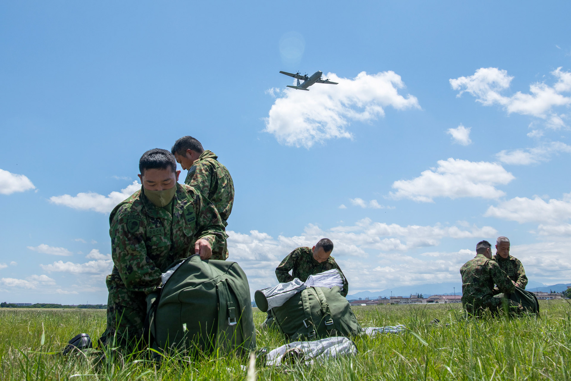 Japan Ground Self-Defense Force paratroopers assigned to the 1st Airborne Brigade pack their parachutes after a military free fall demonstration during the Japanese-American Friendship Festival at Yokota Air Base, Japan, May 22, 2022. A six member team comprised of U.S. Air Force and JGSDF paratroopers, conducted a military free fall demonstration to show their capabilities during the festival. During the two-day festival, more than 110,000 attendees came to Yokota to experience the event. The festival is aimed at increasing bilateral relationships between U.S. and Japanese communities and allows people to see U.S. and Japanese military capabilities first-hand. (U.S. Air Force photo by Yasuo Osakabe)