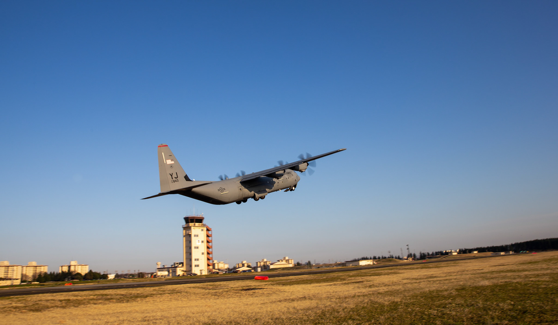 A C-130J Super Hercules assigned to the 36th Airlift Squadron takes off from Foxtrot taxiway at Yokota Air Base, Japan, March 26, 2020. A C-130J used Foxtrot taxiway here as a landing zone for an assault landing for the first time. Training like this ensures the mission can continue at the Yokota airfield despite any potential setbacks that impact operations to the main runway. (U.S. Air Force photo by Yasuo Osakabe)