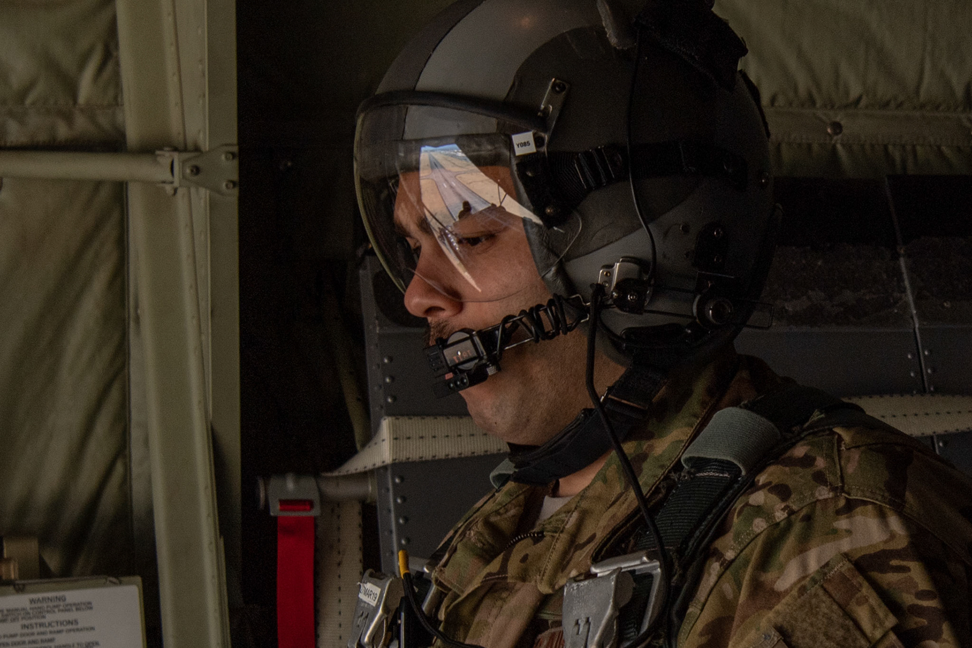 Tech. Sgt. Brian Gates, 36th Airlift Squadron C-130J loadmaster, observes a low-cost low-altitude bundle airdrop during the Yokota C-130J Rodeo over Yokota Air Base, Japan, March 22, 2019, during the Yokota C-130J Rodeo. The 36th Airlift Squadron held a tactical airlift Rodeo competition to test and improve combat tactics in a competitive environment with a split focus on pilot and loadmaster skills. (U.S. Air Force photo by Yasuo Osakabe)