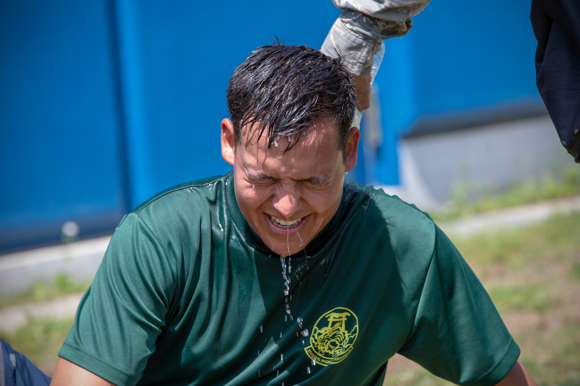 Airman 1st Class Matthew Byce, 374th Civil Engineer Squadron structural apprentice, gets drenched with a cold water after finished four-person relay during an Ability to Survive and Operate (ATSO) Rodeo at Yokota Air Base, Japan, June 8, 2018. The rodeo involved participants wearing different stages of mission-oriented protective posture (MOPP) gear after pushing a Humvee and going through various areas of training including self-aid and buddy care, post-attack reconnaissance, four-person relay, and "shoot, move and communicate." (U.S. Air Force photo by Yasuo Osakabe)
