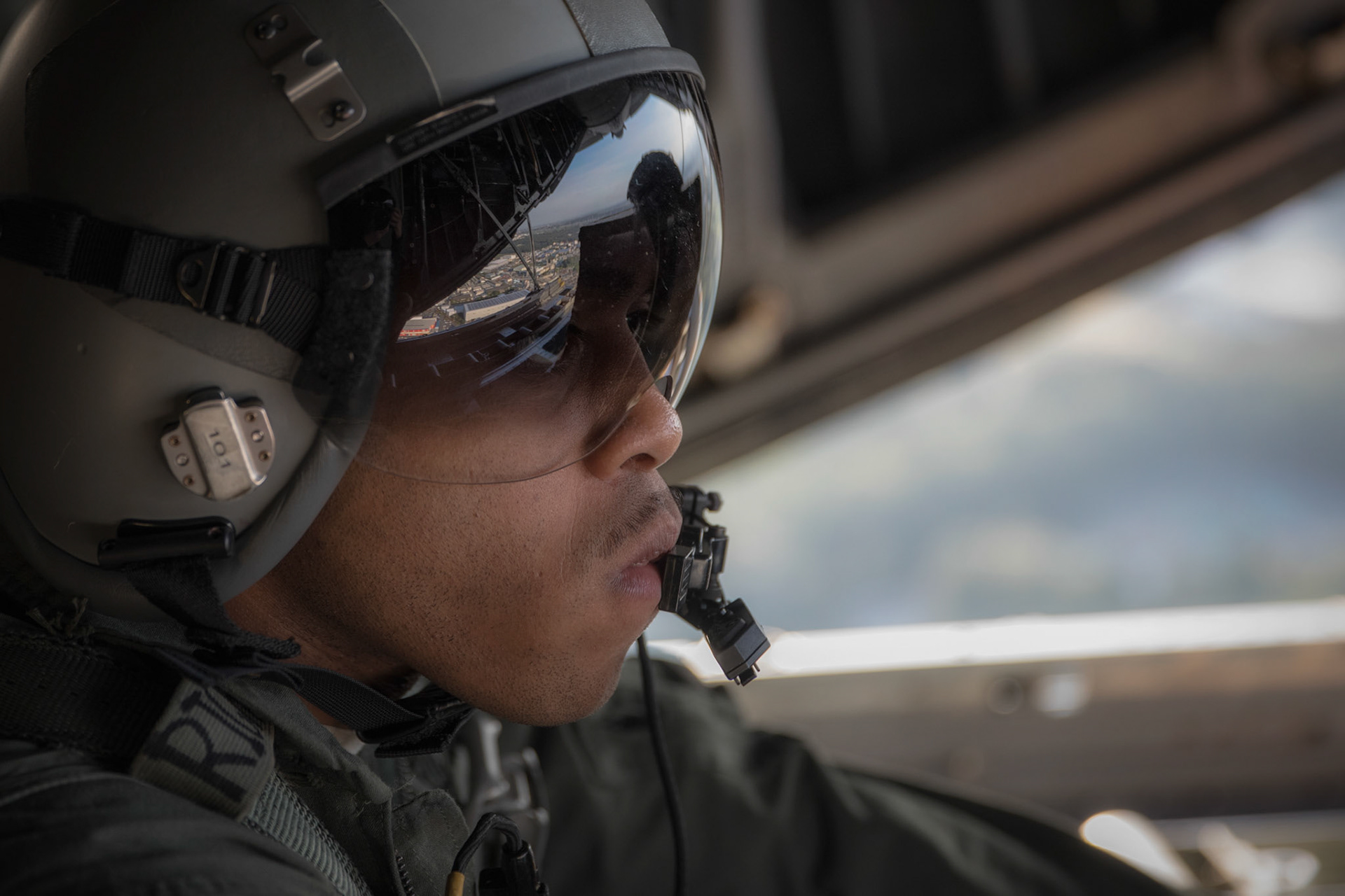 Senior Airman Gary Coe, 36th Airlift Squadron C-130H loadmaster, observes a low-cost, low-altitude bundle drop from a C-130H Hercules over Yokota Air Base, Japan, Oct. 5, 2017. This is the last time active duty C-130H Hercules' crew members perform an LCLA airdrop. (U.S. Air Force photo by Yasuo Osakabe)