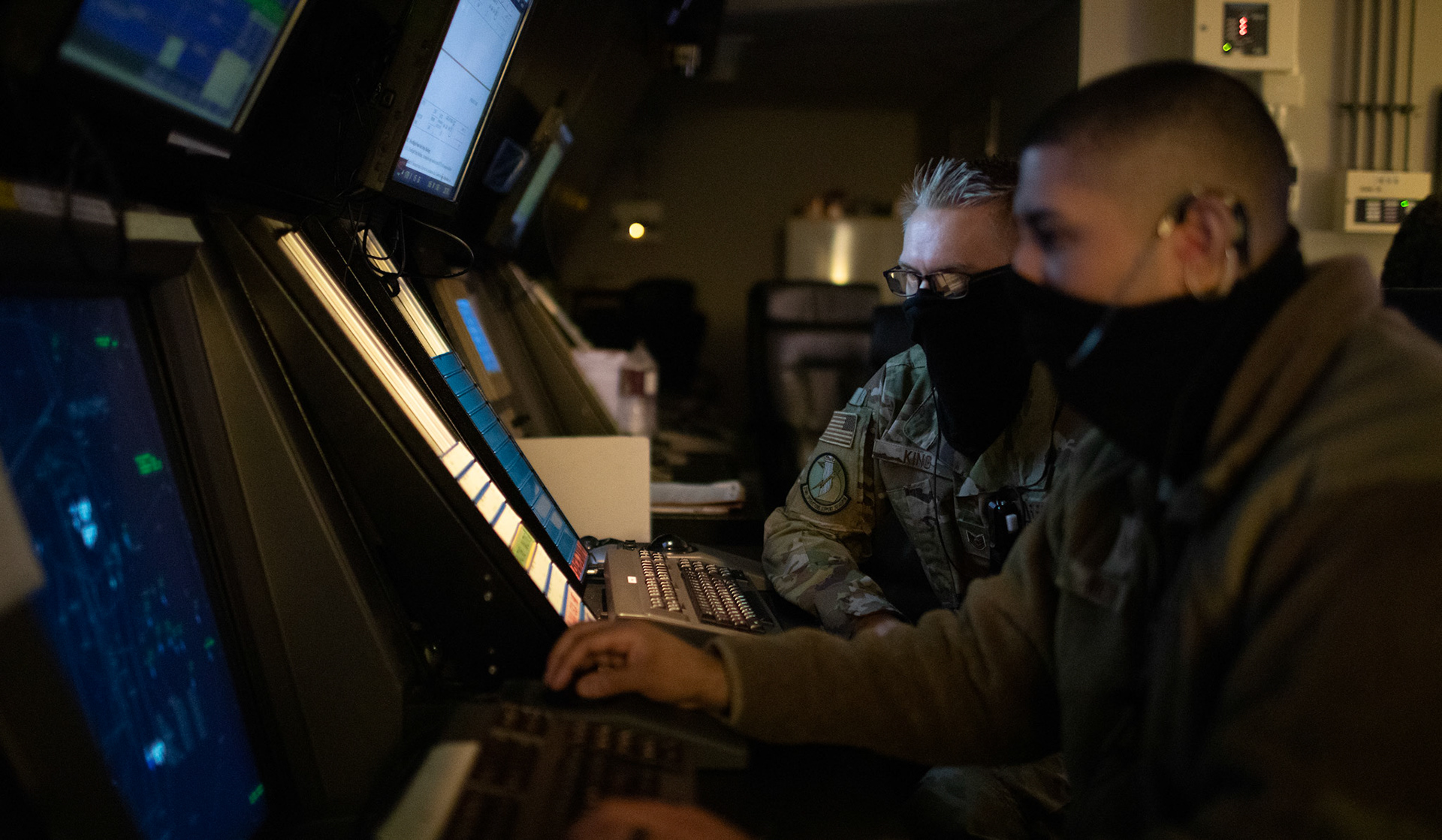 (Right to left) Tech.Sgt. Jason Medina and James King, both 374th Operations Support Squadron air traffic control watch supervisors, read radar scopes and communicate with pilots flying through the air space, June 11, 2020 at Yokota Air Base, Japan. Radar scopes allow air traffic controllers to view aircraft and local weather conditions. (U.S. Air Force photo by Yasuo Osakabe)