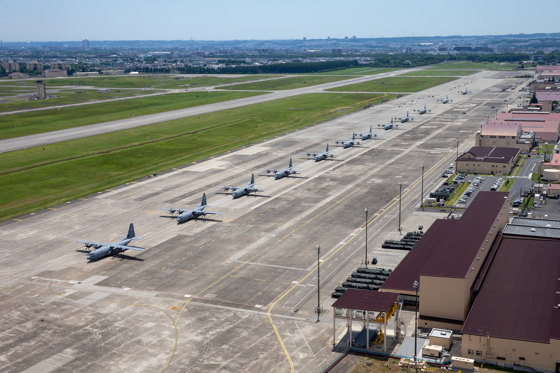 Twelve C-130J Super Hercules from the 36th Airlift Squadron take part in an elephant walk before taking off during the 374th Airlift Wing (AW) Generation Exercise at Yokota Air Base, Japan, May 4, 2018. The 374th AW conducted the exercise to train the wing’s ability to rapidly provide humanitarian aid and disaster relief throughout the Indo-Pacific region. (U.S. Air Force photo by Yasuo Osakabe)