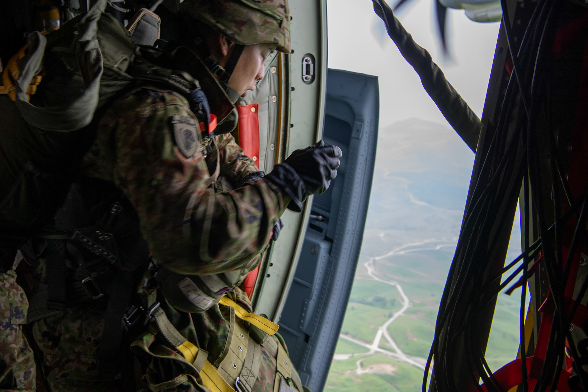 A Japan Ground Self-Defense Force soldier assigned to the 1st Airborne Brigade jumps from a U.S. Air Force C-130J Super Hercules from the 36th Airlift Squadron over Hiju-dai exercise area, Oita prefecture, Japan, July 16, 2019, during a bilateral jump training. The training allows USAF and JGSDF units to work alongside each other while improving the readiness of our armed forces. (U.S. Air Force photo by Yasuo Osakabe)