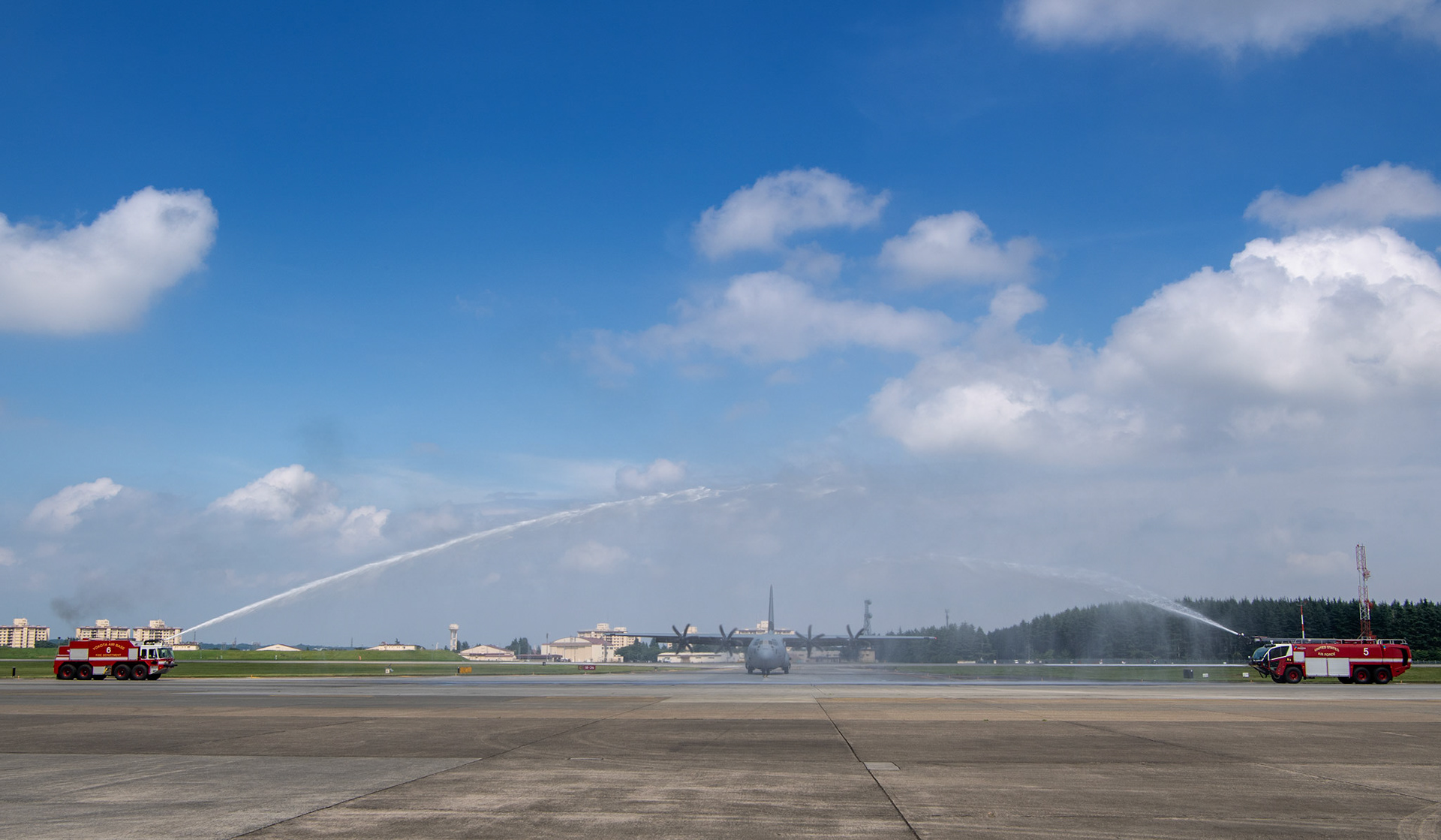 Fire engines with the 374th Civil Engineer Squadron Fire Department give Col. Barry King, 374th Operations Group deputy commander, a water salute after he completes his fini-flight at Yokota Air Base, Japan, July 23, 2019. The fini-flight is a time honored aviation tradition which marks the end of King’s flying status as a command pilot. (U.S. Air Force photo by Yasuo Osakabe)